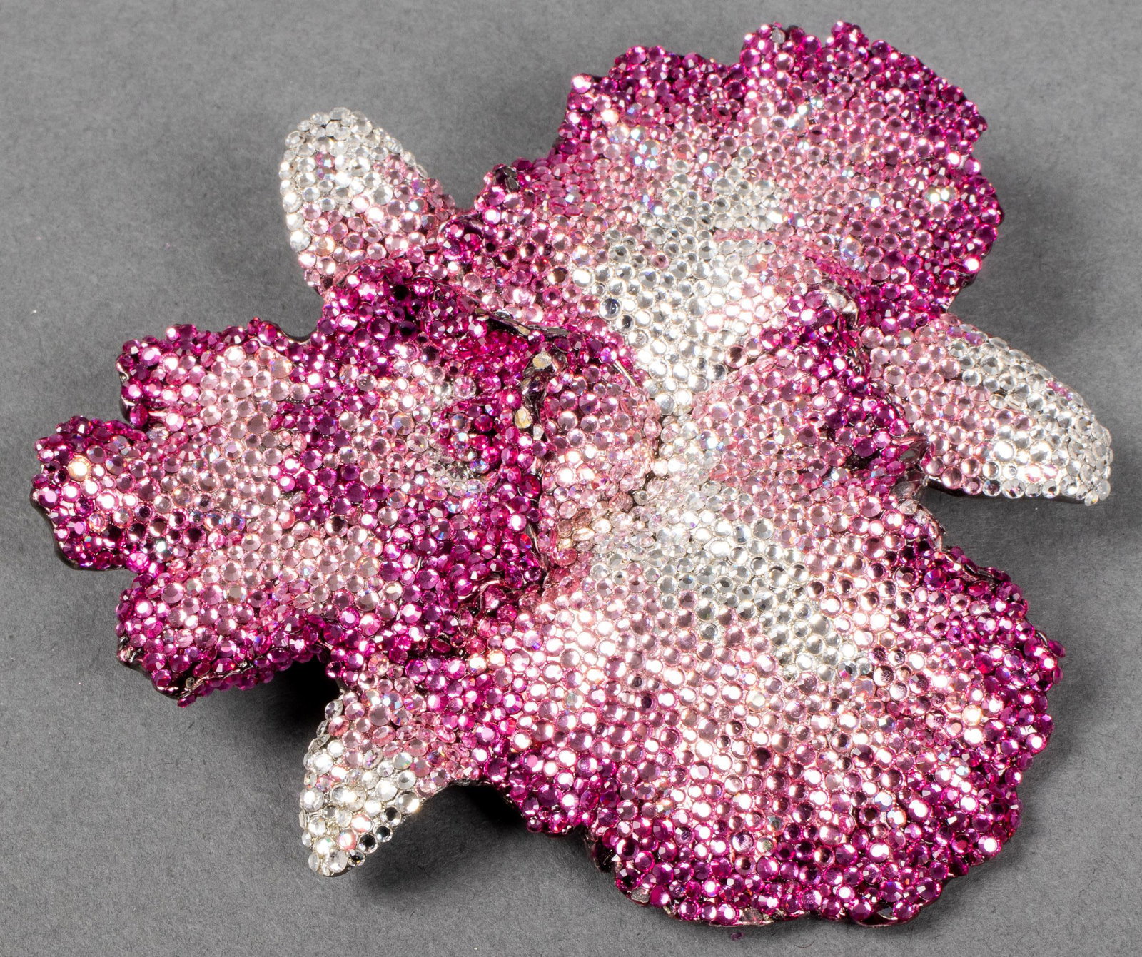 Kathrine Baumann Crystal Flower Buckle: Kathrine Baumann pink and white crystal encrusted buckle in the form of a flower, marked to underside: "Kathrine Baumann 1994 Beverly Hills." 5.4" diameter. Minor crystal loss.