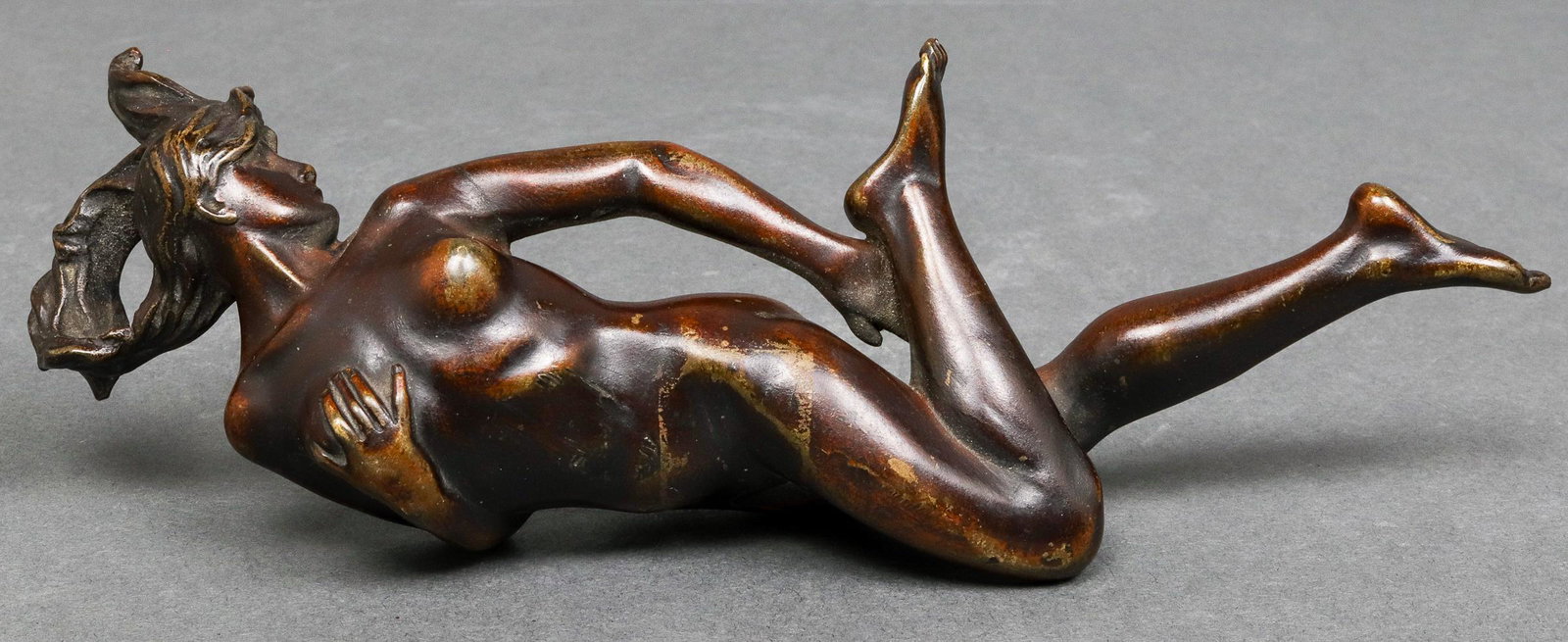 Art Nouveau Female Nude Bronze: Art Nouveau bronze sculpture / mount, depicting a reclining female nude. 3.5" H x 7.75" W x 1.625" D.