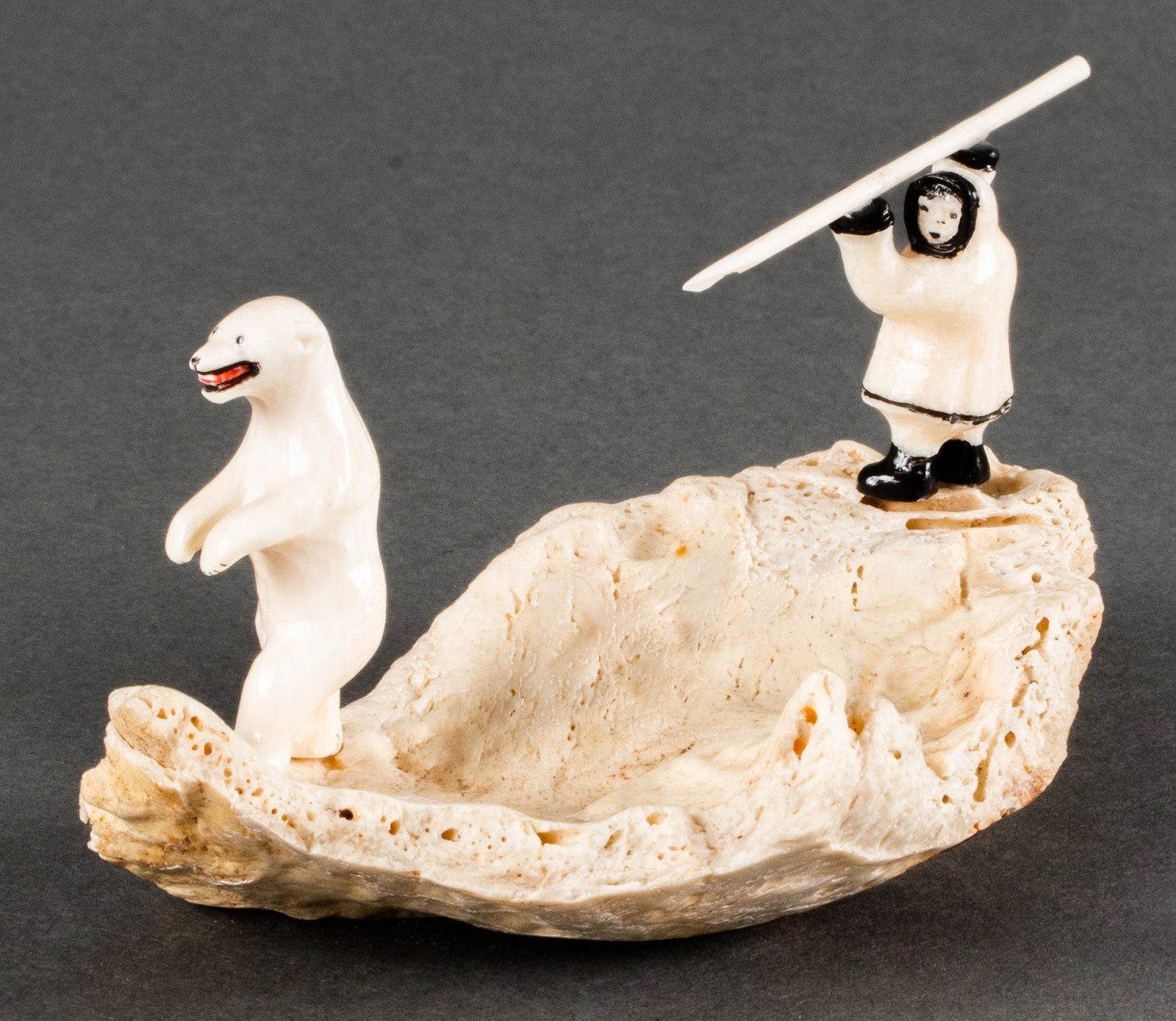 "Polar Bear Hunt" Inuit Carved Figural Sculpture: Inuit carved bone figural sculpture depicting man hunting a polar bear, mounted to bone base. 2.375" H x 5" L.