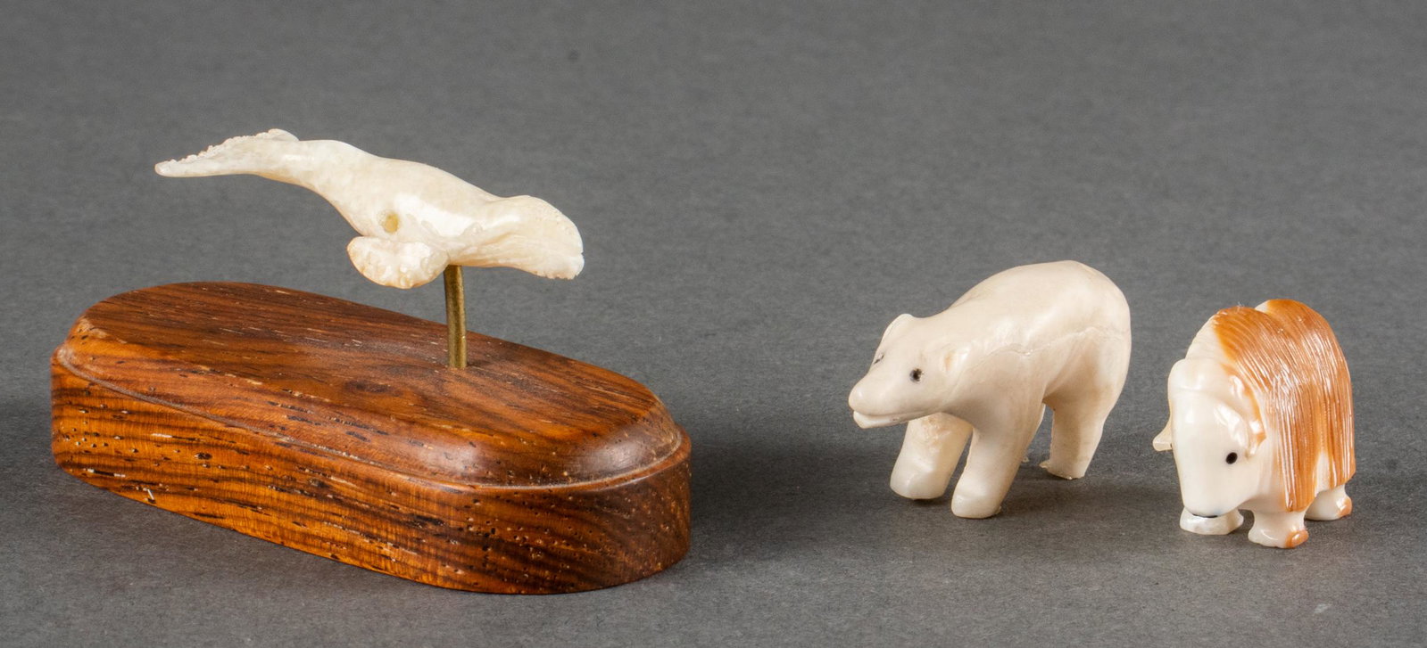 R.B. Kokuluk & Other Miniature Inuit Carvings, 3: Group of three miniature Inuit carved bone Arctic animal sculptures, including R.B. Kokuluk signed muskox, a bear, and a whale mounted to wood block base. Muskox: 0.75" H x 1" D.