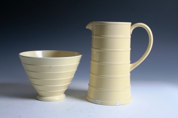 Keith Murray Wedgewood Ceramic Pitcher & Bowl: Keith Murray for Wedgewood pitcher-and-bowl set marked on the underside "Made in England, Matt Straw". Dimensions: Pitcher, 9-1/2" x 5-1/2"; bowl, 7-1/2" x 6"Condition: Restoration to base of pitcher.