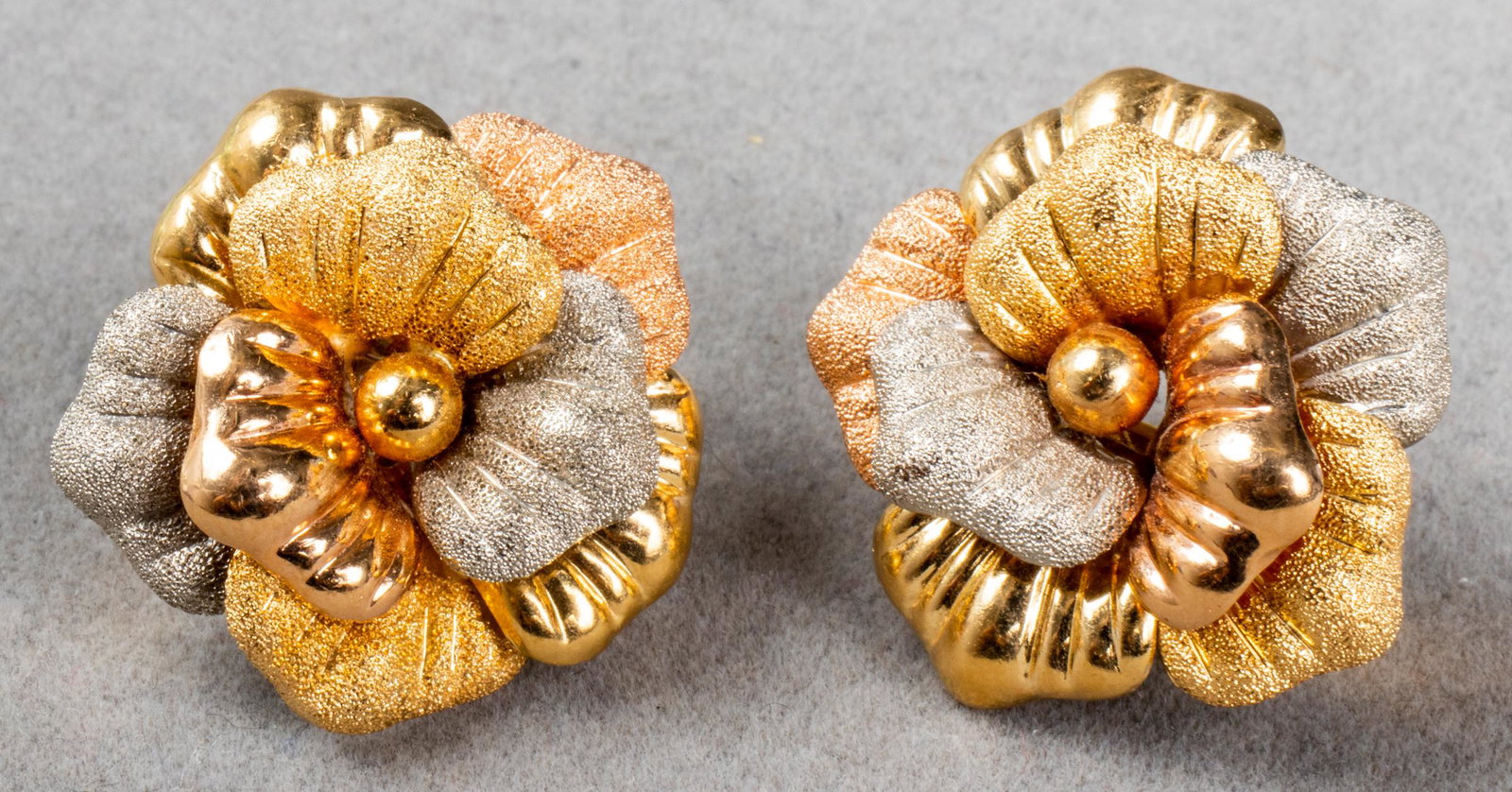 Vintage 18K Tri-Gold Rose Motif Earrings: Vintage 18K tri-gold (yellow gold, white gold and rose gold) sandblasted and high polished finish rose motif post earrings with omega backs, marked: "750 / 1055A," with maker's mark. 1.0" L x 1.0" W x