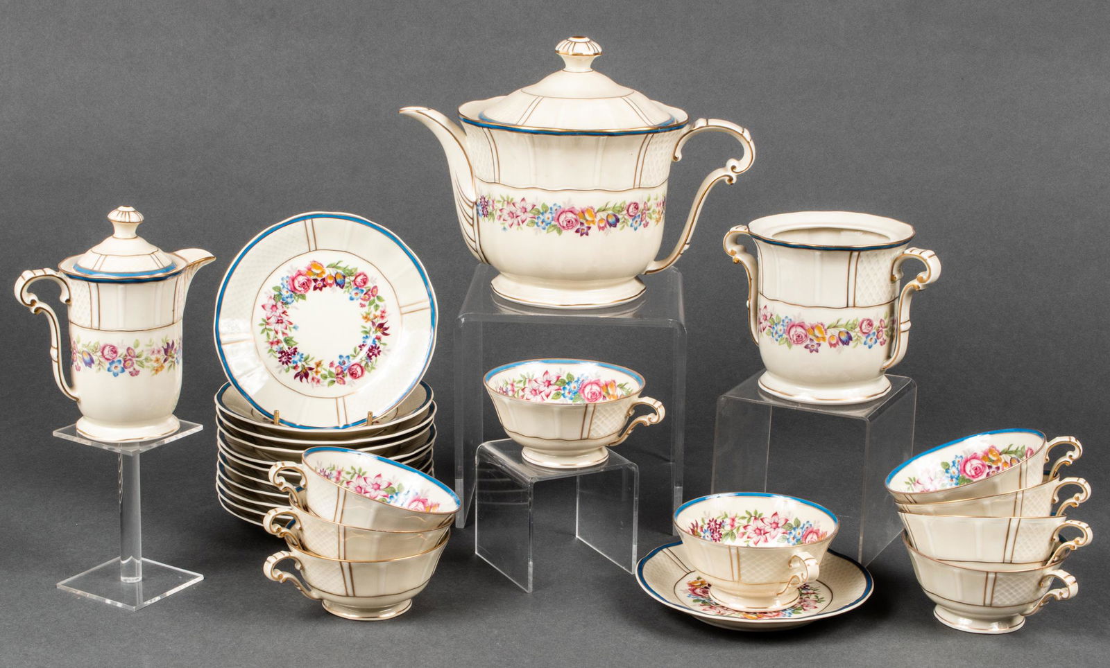 Bernardaud Limoges Porcelain Coffee/Tea Service,24: Bernardaud Limoges paint and gilt decorated partial coffee/tea service, with blue borders and floral motifs throughout, comprising 9 cups, 12 saucers, one coffee/tea pot, one creamer, and one sugar ve