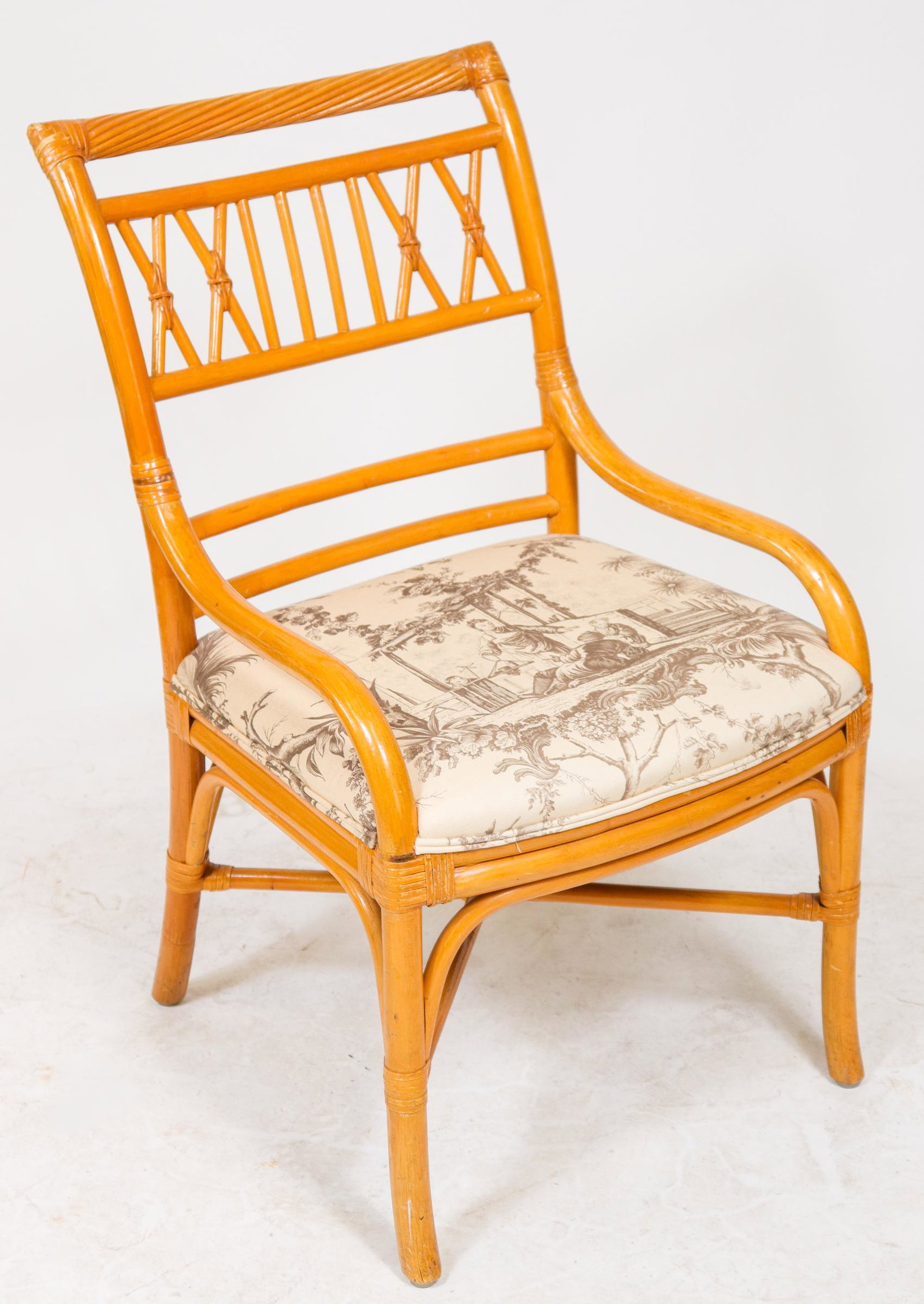 McGuire Bamboo Upholstered Arm Chair: McGuire bamboo armchair with Chinoiserie motif upholstered seat, brown print over cream ground. 34.5" H x 21" W x 24" D.