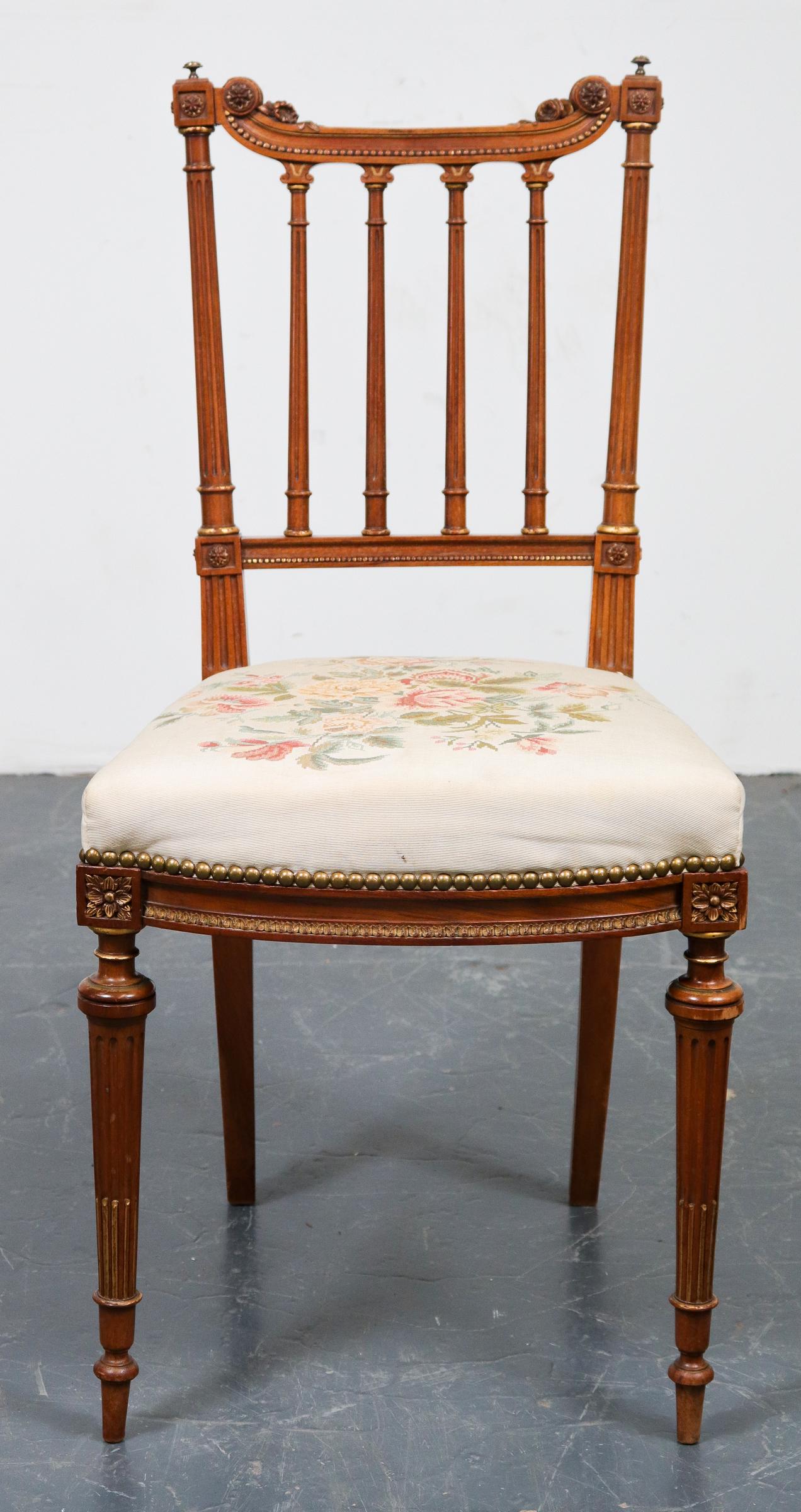 Louis XVI Manner Carved Fruitwood Side Chair: Louis XVI manner parcel gilt carved fruitwood side chair, 20th century, 34.5" H x 16.5" W x 17" D.