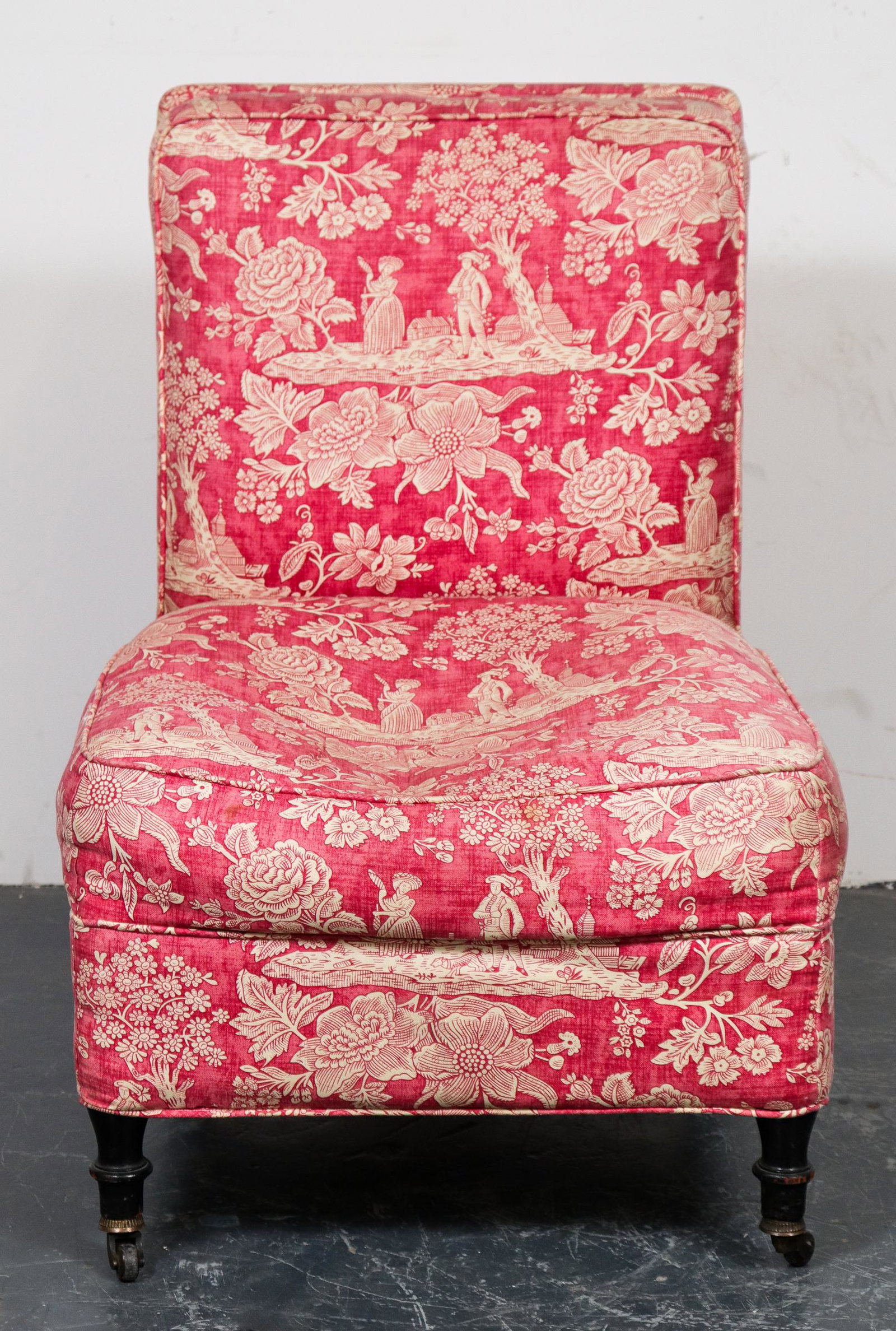 Upholstered Rolling Slipper / Side Chair: Slipper or side chair with caster-mounted feet, red English countryside motif upholstery. 33.5" H x 23" W x 25" D.