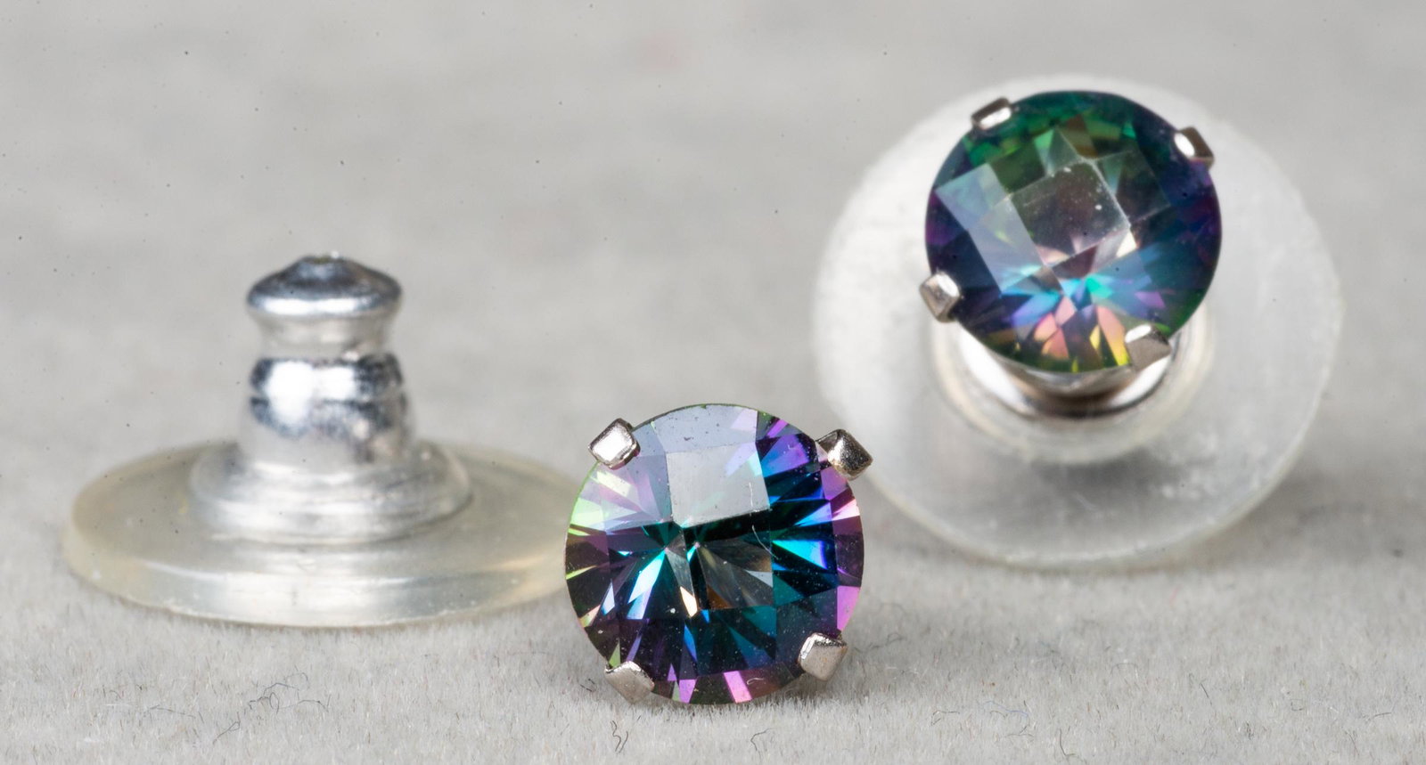 14K White Gold Mystic Topaz Stud Earrings: 14K white gold 6mm round faceted mystic topaz stud earrings, marked: "SAM/14KT", 0.625"L x 0.25"W. Approx: 0.5 dwt. inclusive.