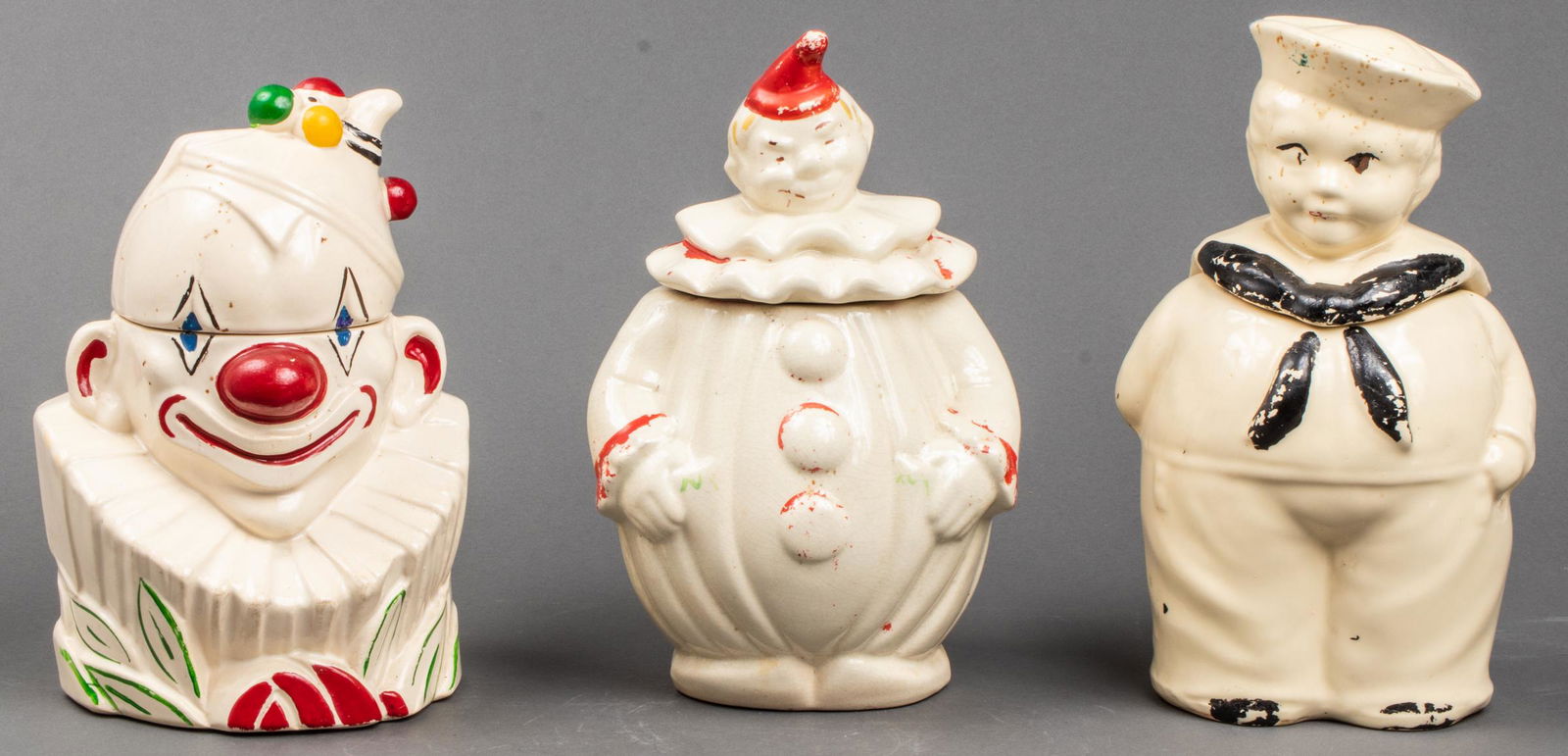 Ceramic Cookie Jars Incl. McCoy Clown, 3 Pcs: A trio of vintage, whimsical hand-painted glazed ceramic cookie jars. Two are in the forms of clowns and the third is a stout sailor boy. The clown bust is marked to underside "McCoy." 3 Pcs. Tallest: