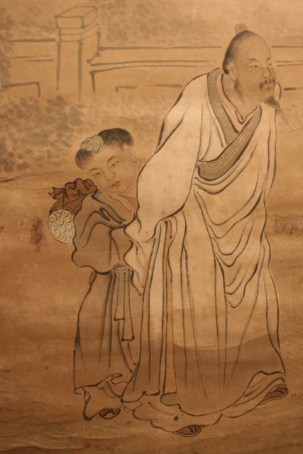 Chinese Scroll - Old Man and Young Boy: Scroll showing an old man and a young boy, calligraphy with marks, ink on paper with silk edging, China, c. twentieth century. Dimensions: Approximately 18-1/4"W x 79"H; image area approximately 14-1/
