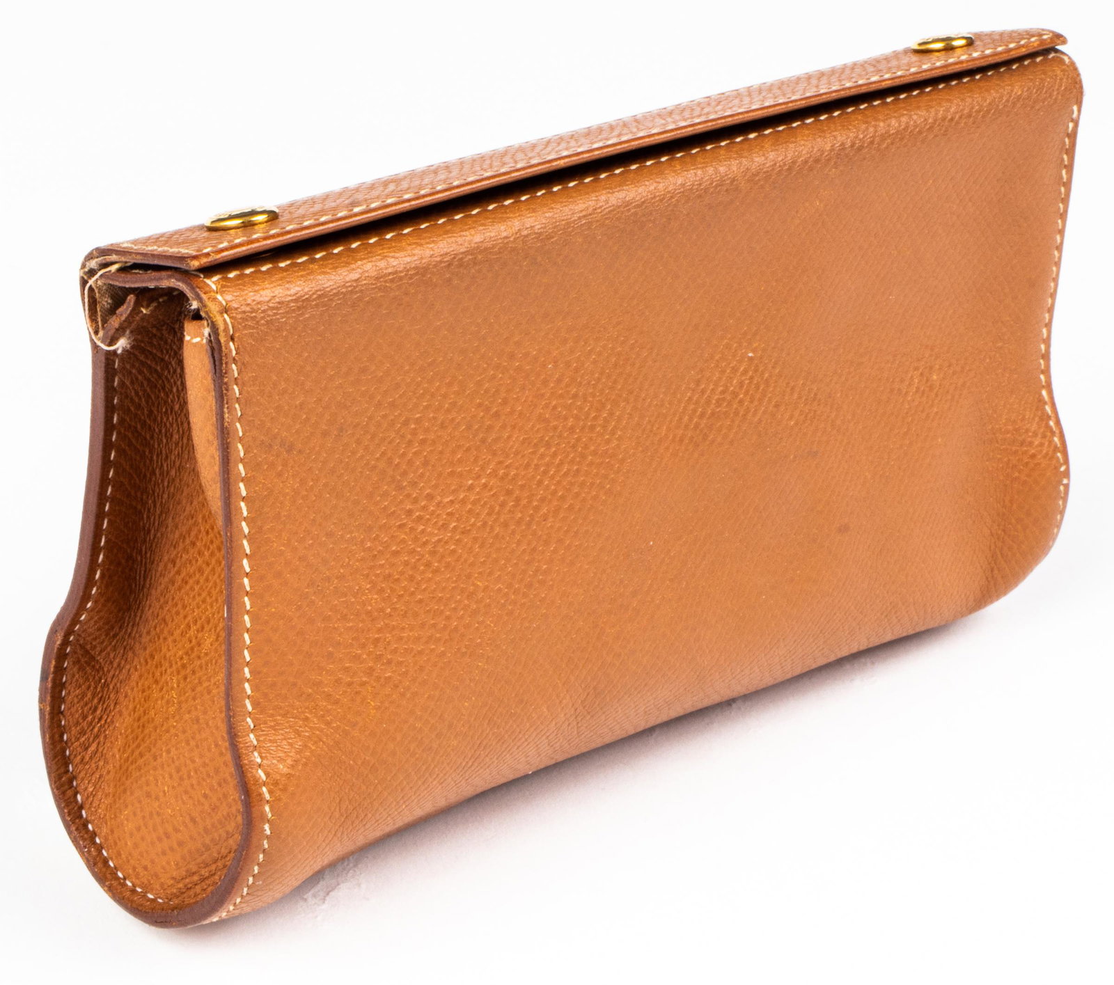 Hermes Brown Leather Karo Pouch / Clutch: Hermes brown leather Karo pouch, the top with two logo buttons and stamped "Hermès Paris Made In France." 3.5” H x 6” W x 2” D. Stains and wear, stitching loose at corners. Property from the Es