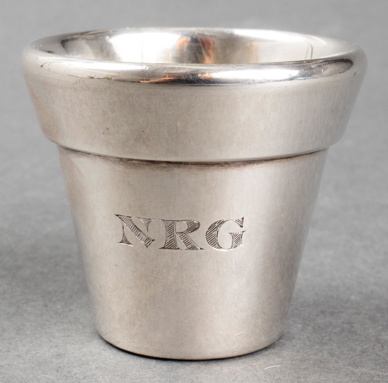 Bulgari Sterling Silver Shot Glass: Bulgari sterling silver shot glass, monogrammed: "NRG" for Nina Griscom, dated underside: "4-16-90," stamped maker's marks on side: "Bvlgari 925." 1.5" H x 1.75" diameter. Approx: 2.17 ozt. Provenance