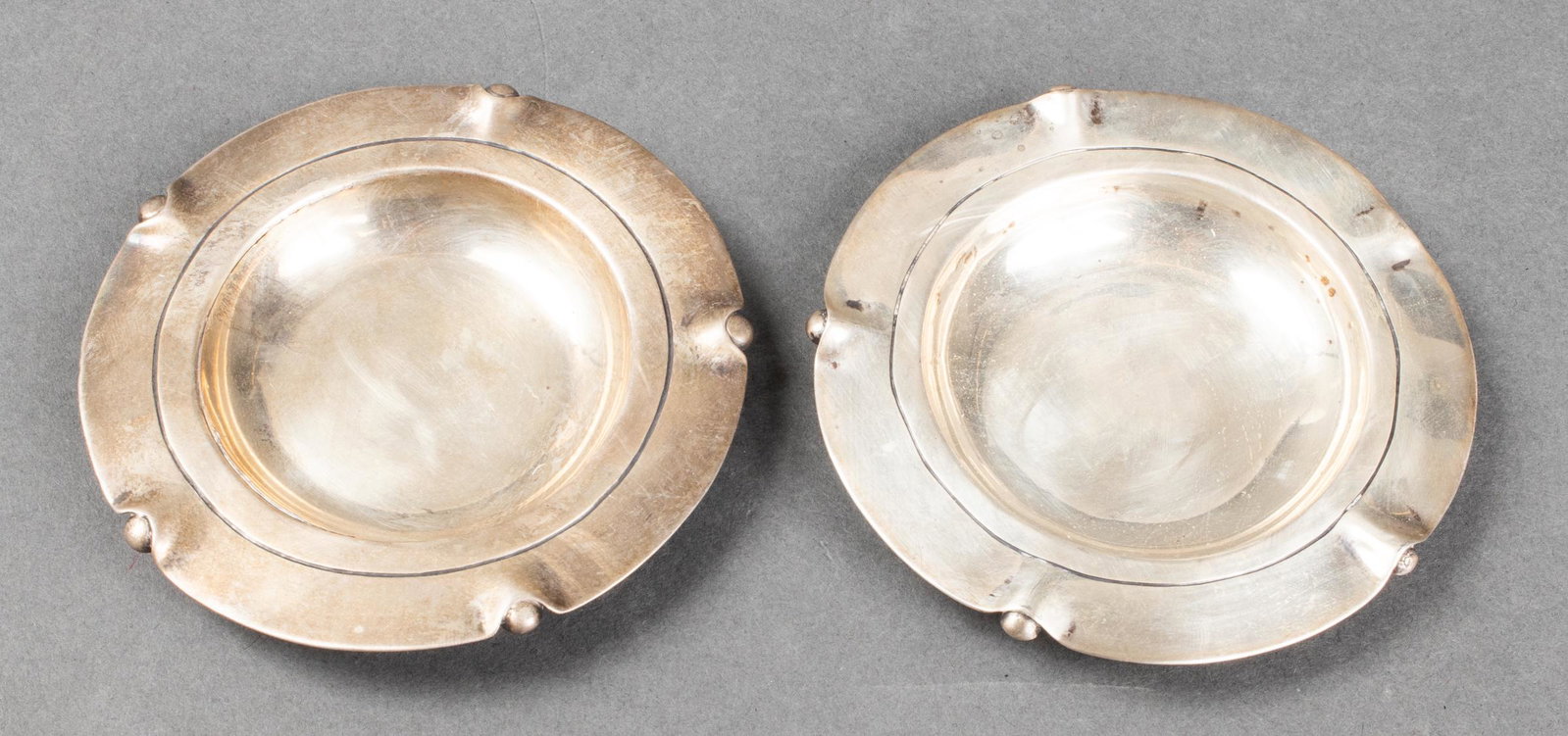 William Spratling Mexican Silver Nut Dishes, Pair: Pair of William Spratling Mexican silver nut dishes, two distinct marks underside including: "Spratling Made in Mexico," and "Spratling Silver." 3.875" diameter. Approx: 3.96 ozt. Provenance: Removed 
