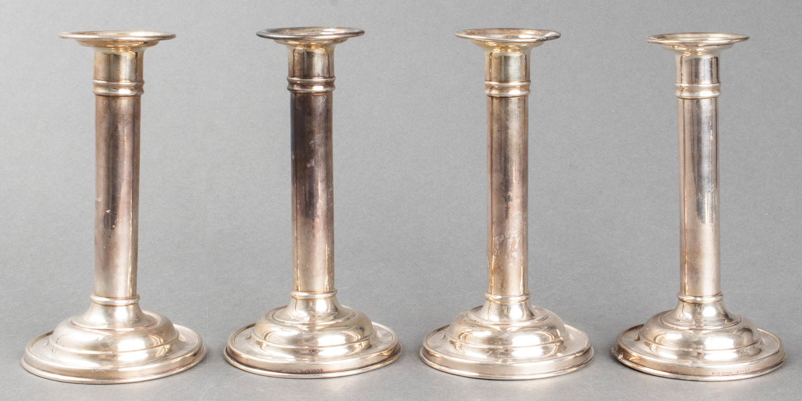 Gorham Sterling Silver Candlesticks, Group of 4: Gorham sterling silver candlesticks, group of four, each engraved "Dr. A" to middle tier of bases, maker's marks to lowest tier of bases, likely lightly weighted. 7" H x 3.75" diameter. Approx: 17.26 