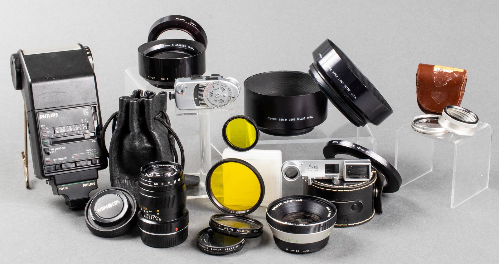 Assorted Camera Equipment for Leica, Rollei, etc.: Assortment of camera equipment including one Minolta Rokkor M-Mount 90mm lens, one Rollei Rolleinar 2 lens attachment, one Leica Leicameter MR light meter, and a variety of accessories from Tiffen, Ni