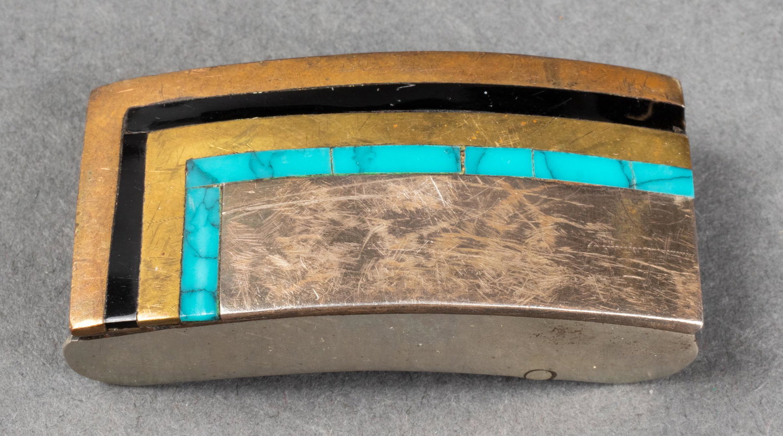 Taxco Silver/Base Metal Onyx Turquoise Belt Buckle: Vintage Taxco Mexican sterling silver and metal onyx and turquoise inlay belt buckle, marked: "STERLING / RAX / TAXCO / 086." 2.0" L x 1.0" W x 0.5" H. Silver not weighable. Provenance: Removed from a