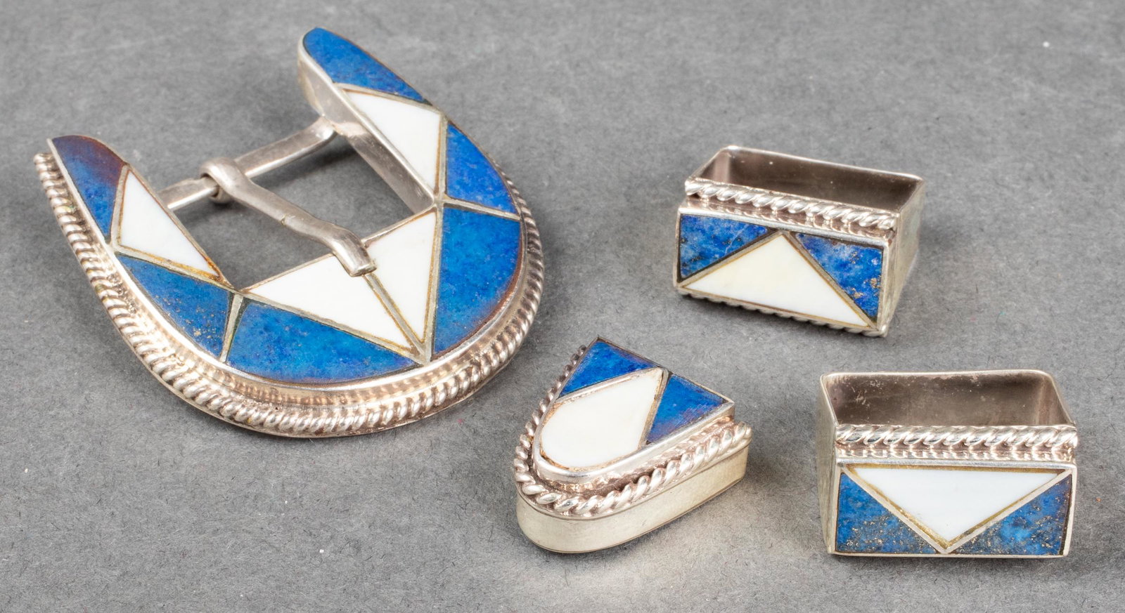 Navajo Silver Lapis & White Onyx Belt Buckle 4 pcs: Vintage Native American Navajo sterling silver four piece lapis lazuli and white onyx belt buckle, marked: "STERLING." Belt buckle: 1.93" L x 1.68" W x 0.5" H. Approx: 1.45 ozt inclusive. Provenance: 