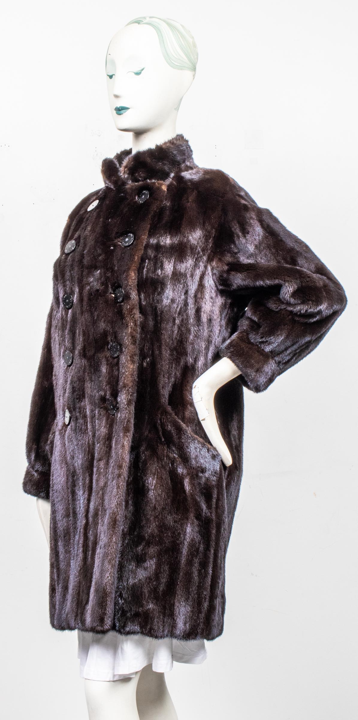 Yves Saint Laurent Brown Mink Fur Coat: Yves Saint Laurent Fourrures brown mink fur coat, the front with double breasted logo button closures and two slant pockets, the interior with black "YSL" logo lining and "Yves Saint Laurent Fourrures