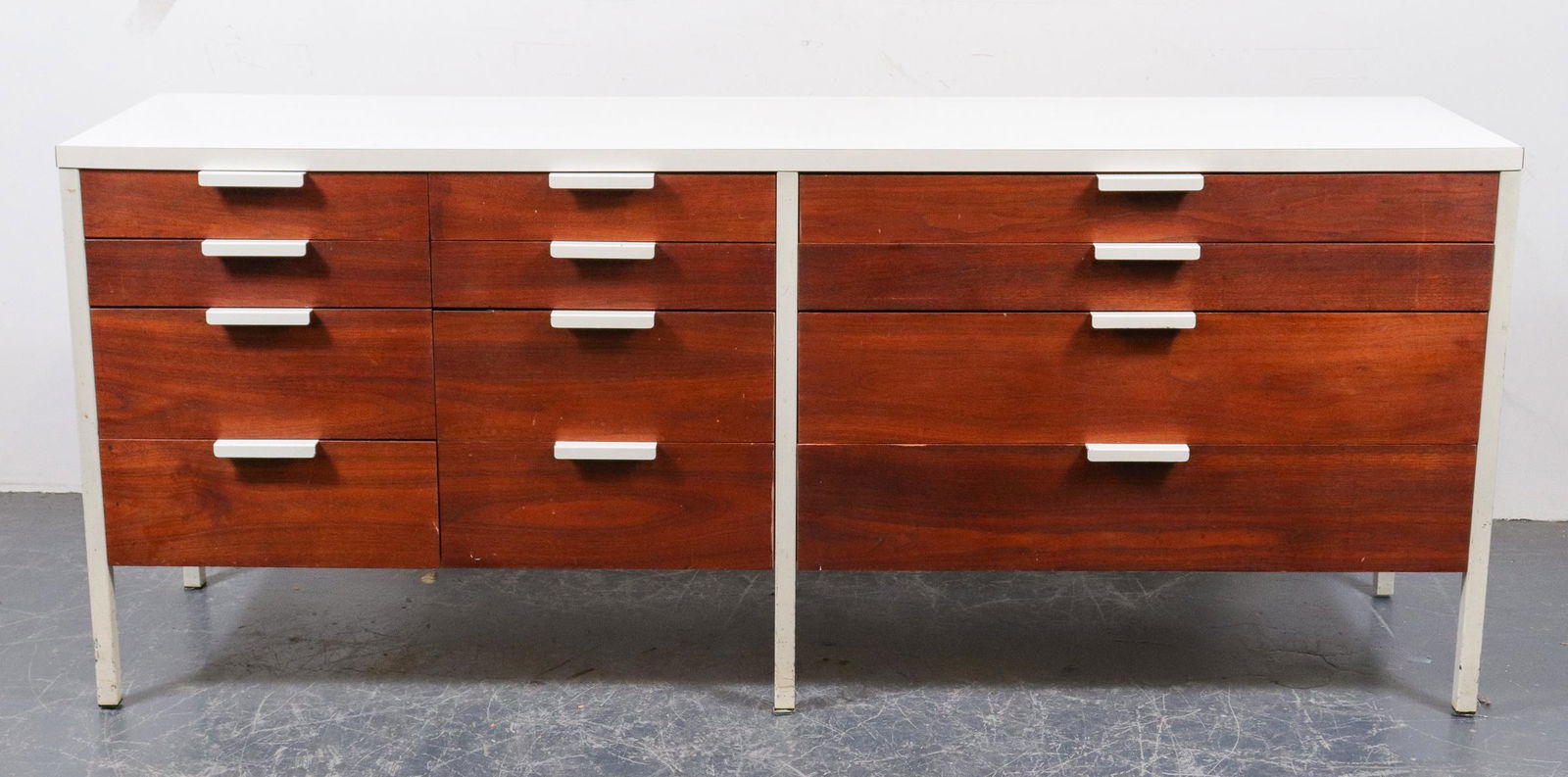 Mid-Century Modern Laminate Top Dresser: Mid-century modern dresser / cabinet with white laminate top and twelve drawers, metal legs with white painted finish. 29.5" H x 70.5" W x 18" D. Light surface wear to finish.