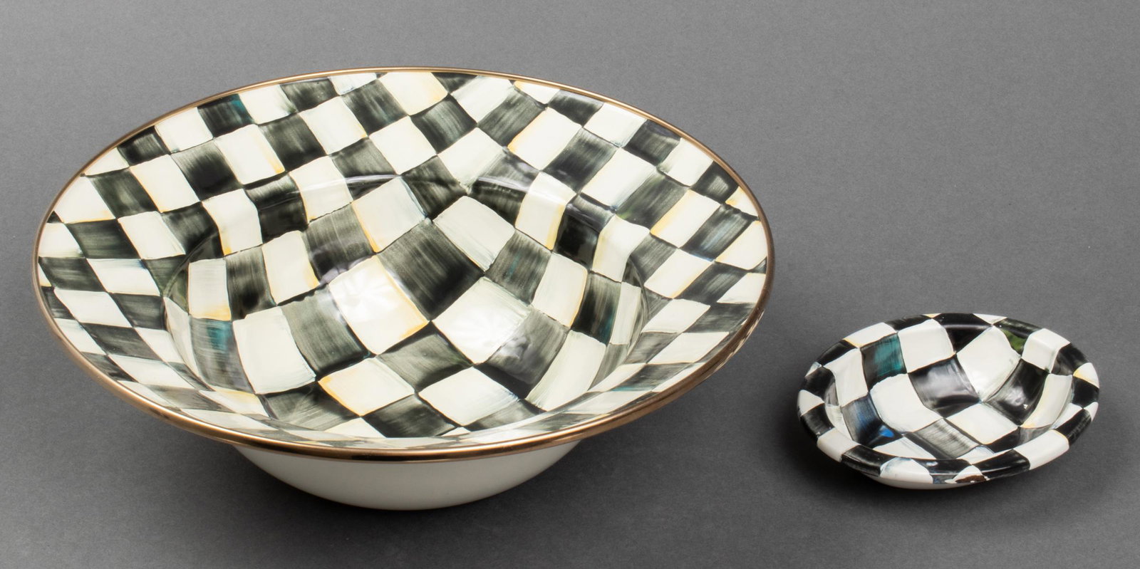 Mackenzie-Childs Courtly Check Enamel Bowls, 2: Mackenzie-Childs enamel bowls in "Courtly Check" pattern, group of two, comprising a centerpiece bowl and a soap dish, each with maker's marks to underside. Larger: 3.75" H x 11.75" diameter. Provenan