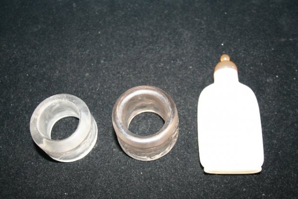 Chinese Agate Snuff Bottle w/2 Crystal Rings: Chinese snuff bottle hand-carved from semi-transparent white agate, and 2 rings hand-carved from arch crystal and decorated in low-relief with diverse animal subjects and a man in a landscape. Dimensi