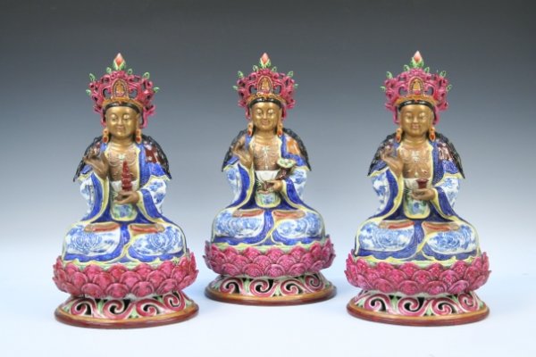 Three Chinese Buddha Statues with Marks: Three Buddha statues, each seating on the lotus base and making a circle with his right hand, which means the mudra for perfection. One is holding a miniature pagoda, the second one is holding a heali