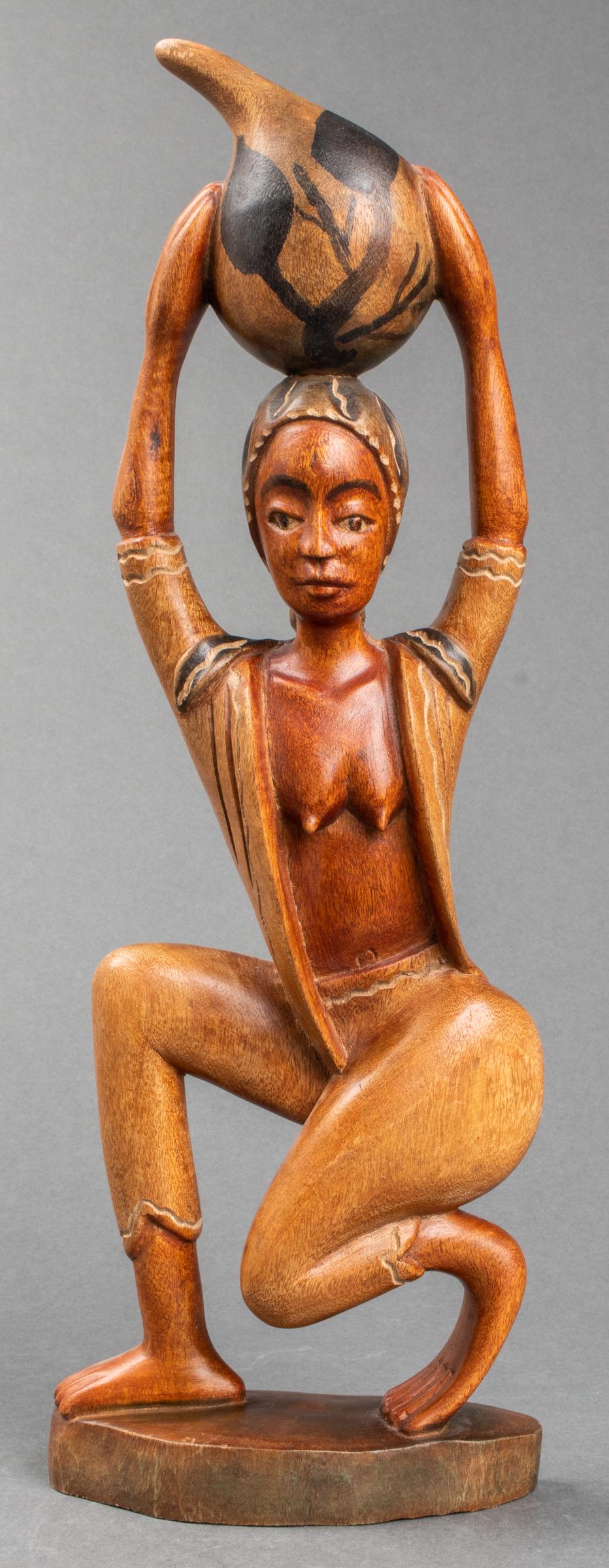 African Carved Wooden Sculputure of Woman: Hand painted sculpture carved from solid wood depicting a woman carrying a water jug, 16" H x 6" W x 2" D.