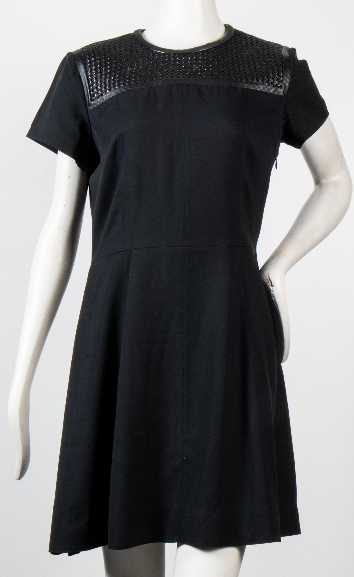 Proenza Schouler Silk Dress W Woven Leather: Proenza Schouler silk blend dress with woven leather yoke, short sleeves, fitted waistline, side zipper closure, designer's label and size "Proenza Schouler / 10" to interior. Shoulders: 16.75" W; bus