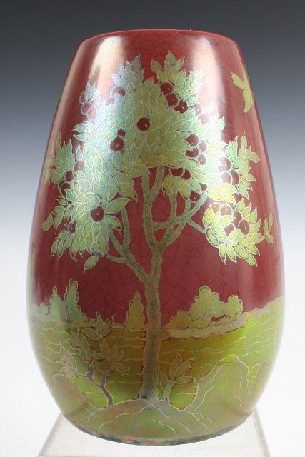 Zsolnay Hungary Japonist Vase c. Early 20th C.: Hungarian ceramic Art-Nouveau-style vase finely decorated with irridescent red and gold-colored glazes. Features a Japonist-style waterside scene showing a fruit tree, rocks, sailboats, and birds in f
