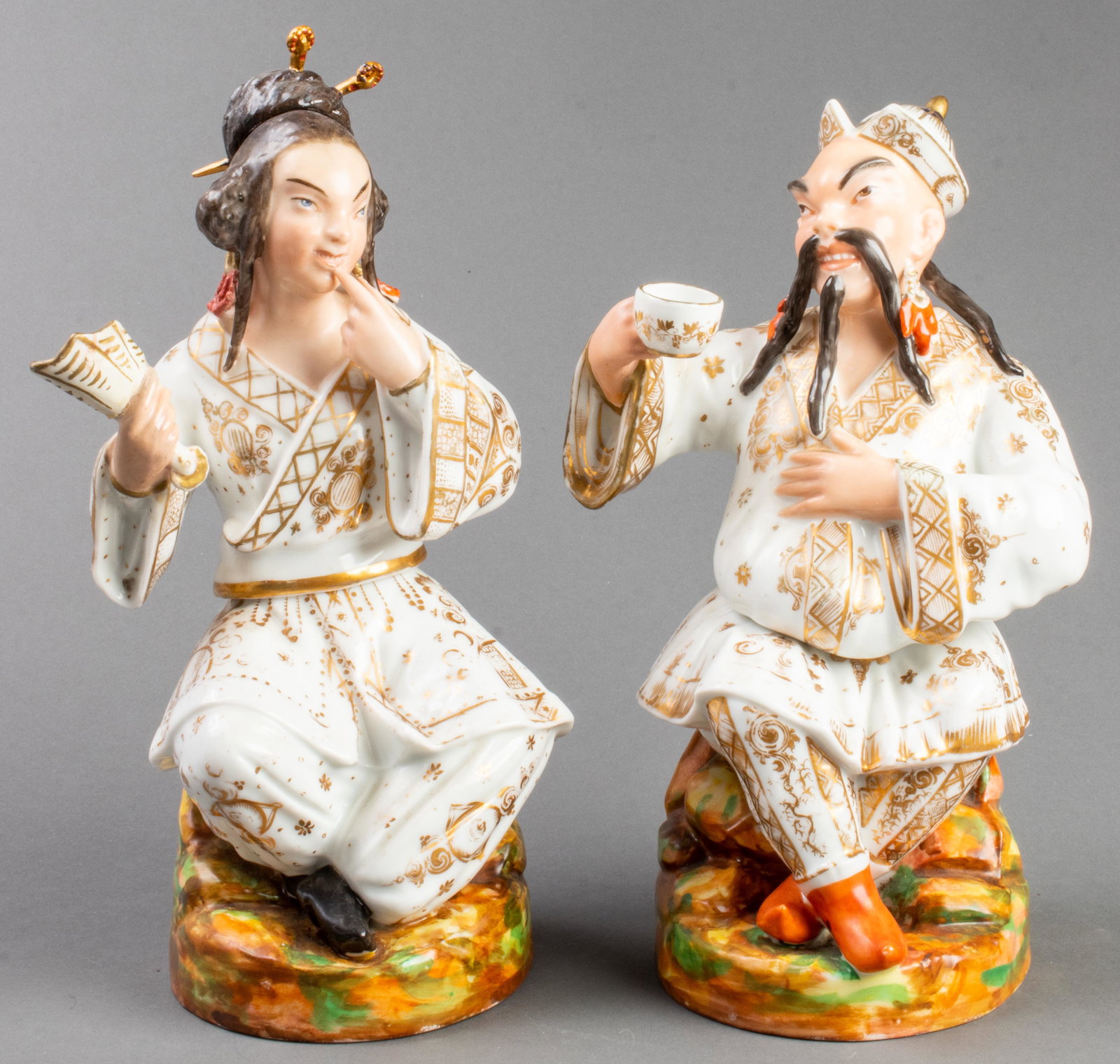 Jacob Petit Attr Porcelain Chinoiserie Figures, Pr: Pair of paint decorated porcelain brûle-parfums or potpourri vessels, attributed to Jacob Petit, modeled as two seated Chinoiserie figures enjoying some tea, the upper sections remove to reveal open