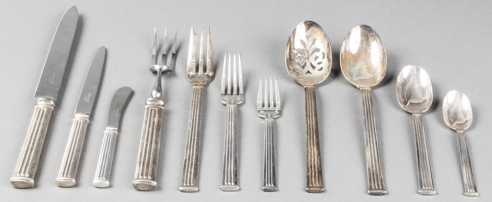 Christofle "Triade" Silver-Plate Flatware Service: Christofle "Triade" pattern silver-plate flatware service, 76 pieces, comprising 12 dinner knives, 11 dinner forks, 12 salad forks, 20 teaspoons, 12 table spoons, 4 individual spreaders, carving knife