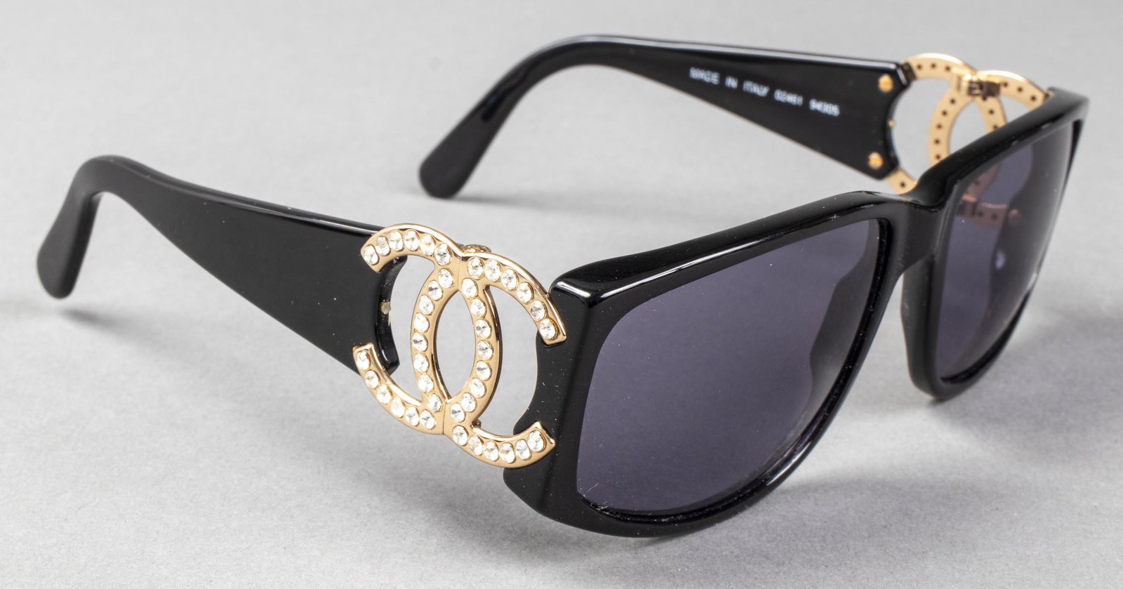 Chanel Designer "CC" Logo Sunglasses: Chanel designer sunglasses, black tone frame with gold tone "CC" logo hinges encrusted with crystals, marked to interior, with trademarked leather hard case and leather soft case with embossed "CC" lo