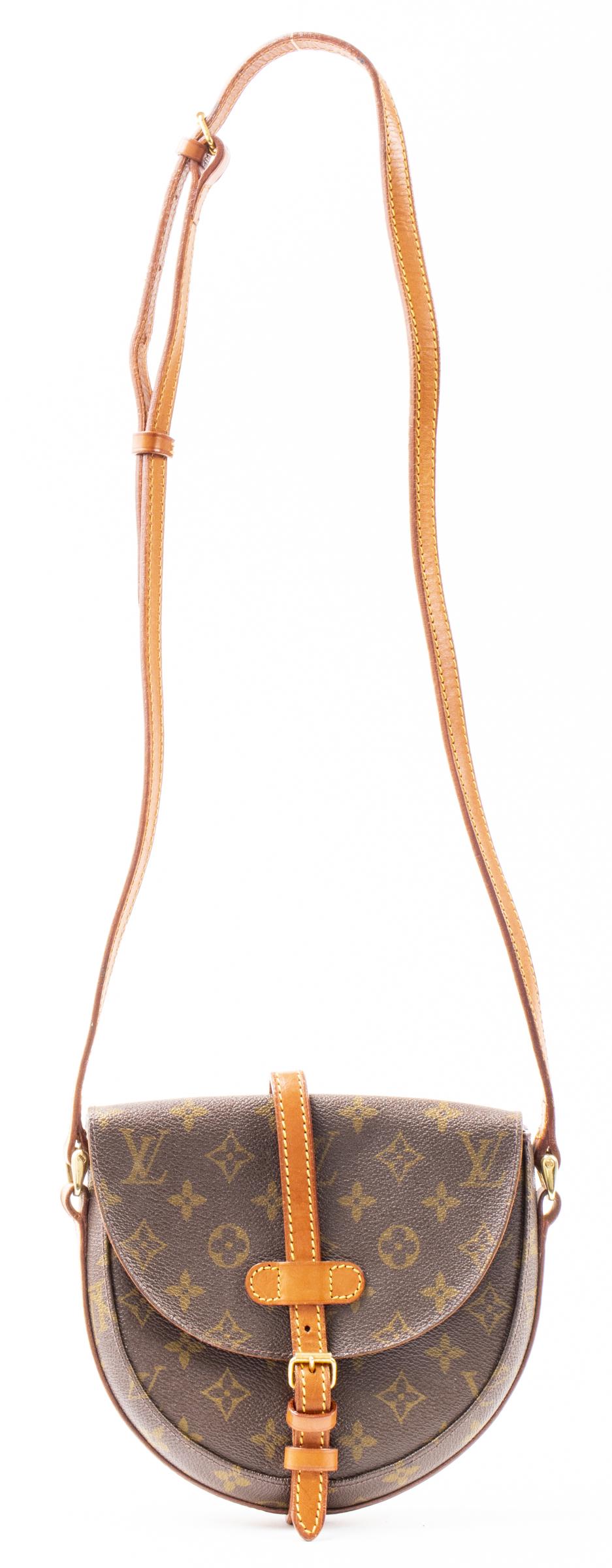 Brown Coated Canvas Handbag: Brown coated canvas handbag with spurious logo. 8" H x 8.5" W x 2" D. Wear.