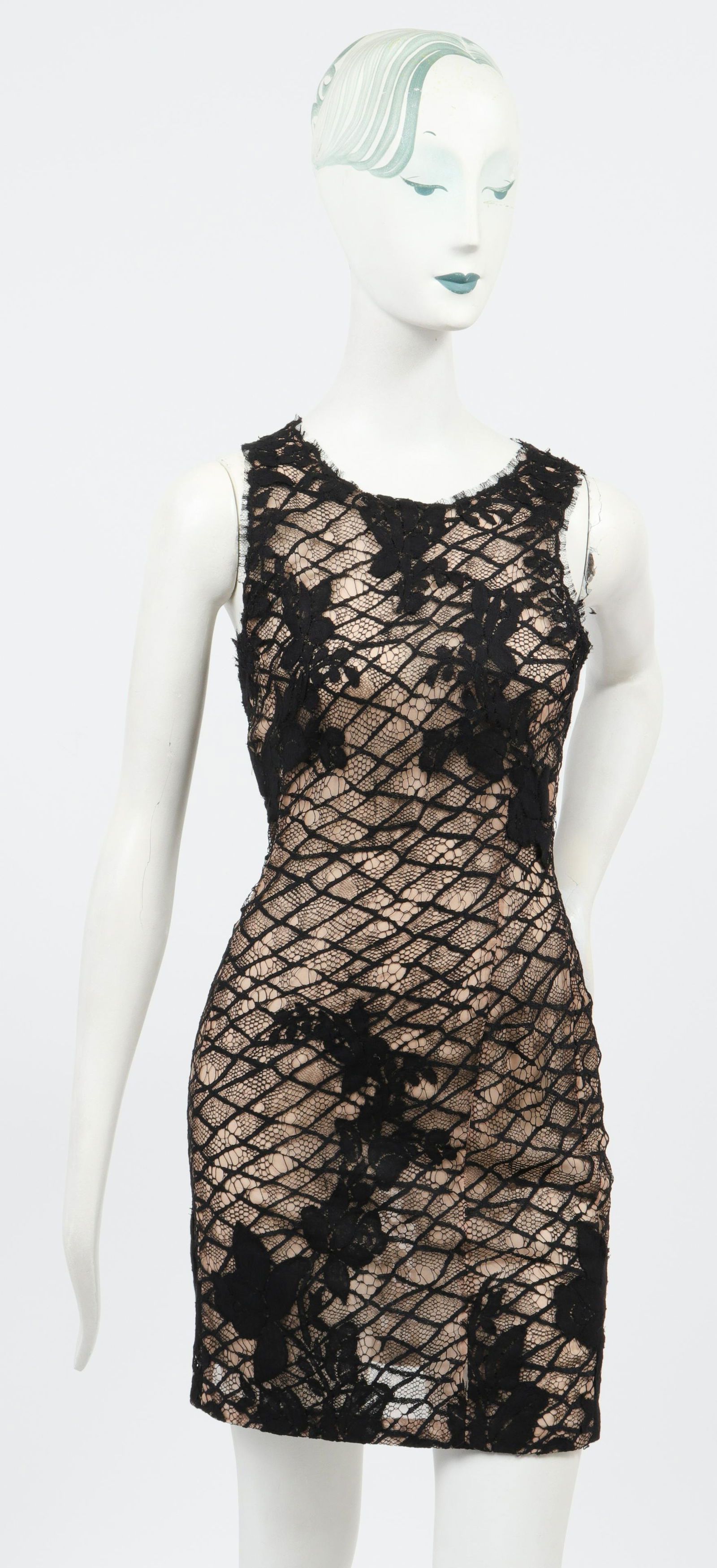 Bill Blass Petite Lace Mini Cocktail Dress: Bill Blass petite lace mini sleeveless cocktail dress, with black lace over sheer nude silk gauze lining, high neck, designer's label "Bill Blass" to interior lining, back zipper closure. Bust: 13" W;