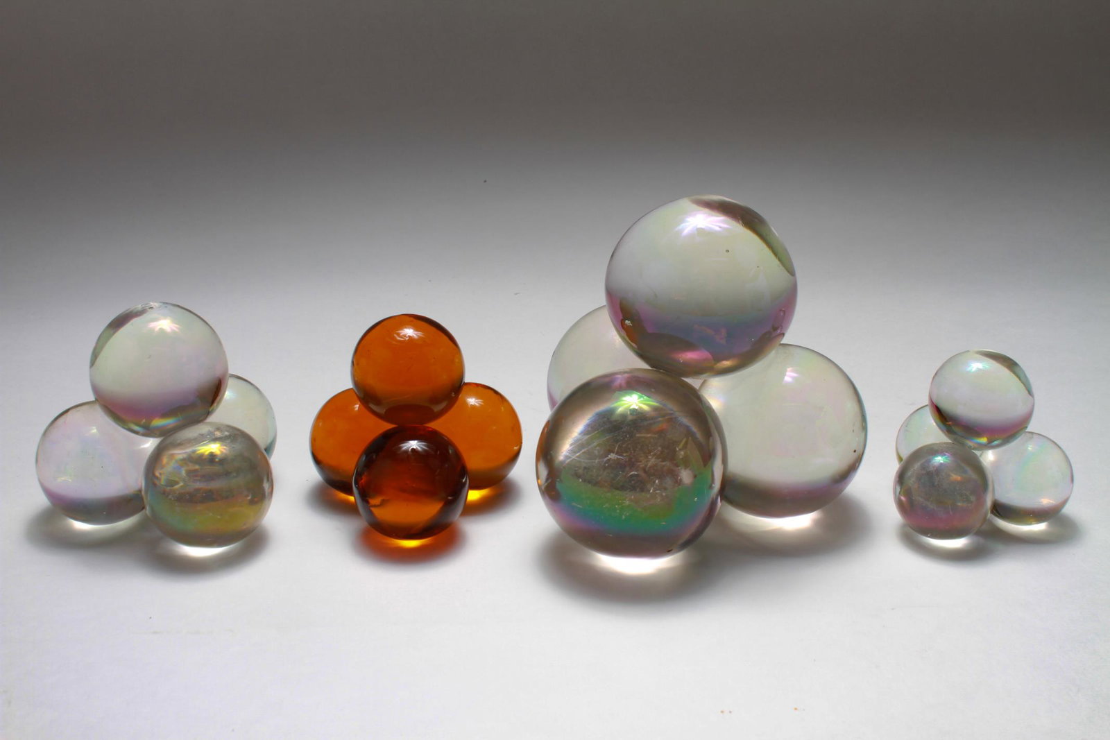 Czech Iridescent Glass Ball Pyramid Paperweights,4: Four Czechoslovakian iridescent art glass ball pyramid paperweights, with one peach example, late 19th / early 20th century, by either F & J Dressler, Gablonz, Bohemia, or Harrach Glassworks, Harracho