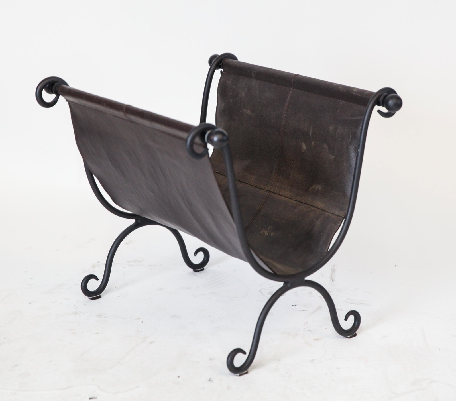 Roman Manner Curule Form Magazine Rack: Roman manner iron and brown leather magazine / newspaper rack, of curule form. 17" H x 18" W x 20.5" D.