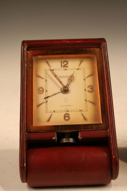Hermes Jaeger-LeCoultre Leather Travel Clock: Small travel clock that opens into stand by Hermes and Jaeger-LeCoultre, leather; marked with maker's names. Dimensions: 4-1/2"L x 2-1/2"W x 1"D