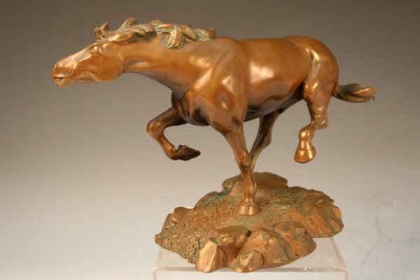 Bronze Sculpture of a Horse by DeWitt 20th C.: Sculpture of a horse running shown with its neck stretched forward and its front-right and left-hind legs lifted off of the rocky terrain base with a felt bottom, by artist Floyd Tennsion DeWitt (Amer