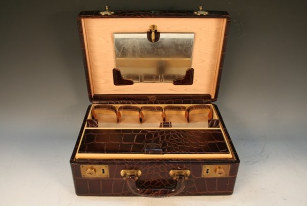 Shortrip Crocodile-Leather Train Make-Up Case: Crocodile-leather train case features original brass hardware and a plastic-lined bottom. Built-in amenities include a mirror, leather key holder, velvet-cushioned jewelry box, and leather bottle hold