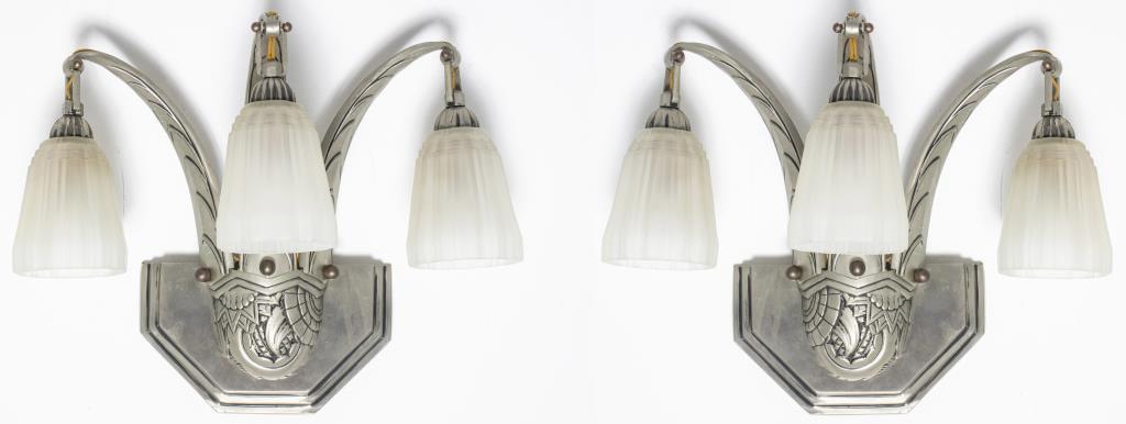 French Art Deco Triple Light Sconces, Pair: Pair of French Art Deco triple light wall sconces featuring frosted molded glass shades mounted to silvered metal frame with floral and geometric motifs, in the manner of Sabino. 16" H x 17" W x 8" D.