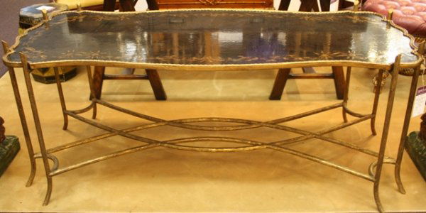 Holly Hunt Chinoiserie Wood Coffee Table 20th C.: Irregularly-shaped, hand-painted coffee table with eight gilded faux-wood legs and cross stretchers and featuring gilt Chinoiserie floral decorations on the tabletop, by luxury home fur