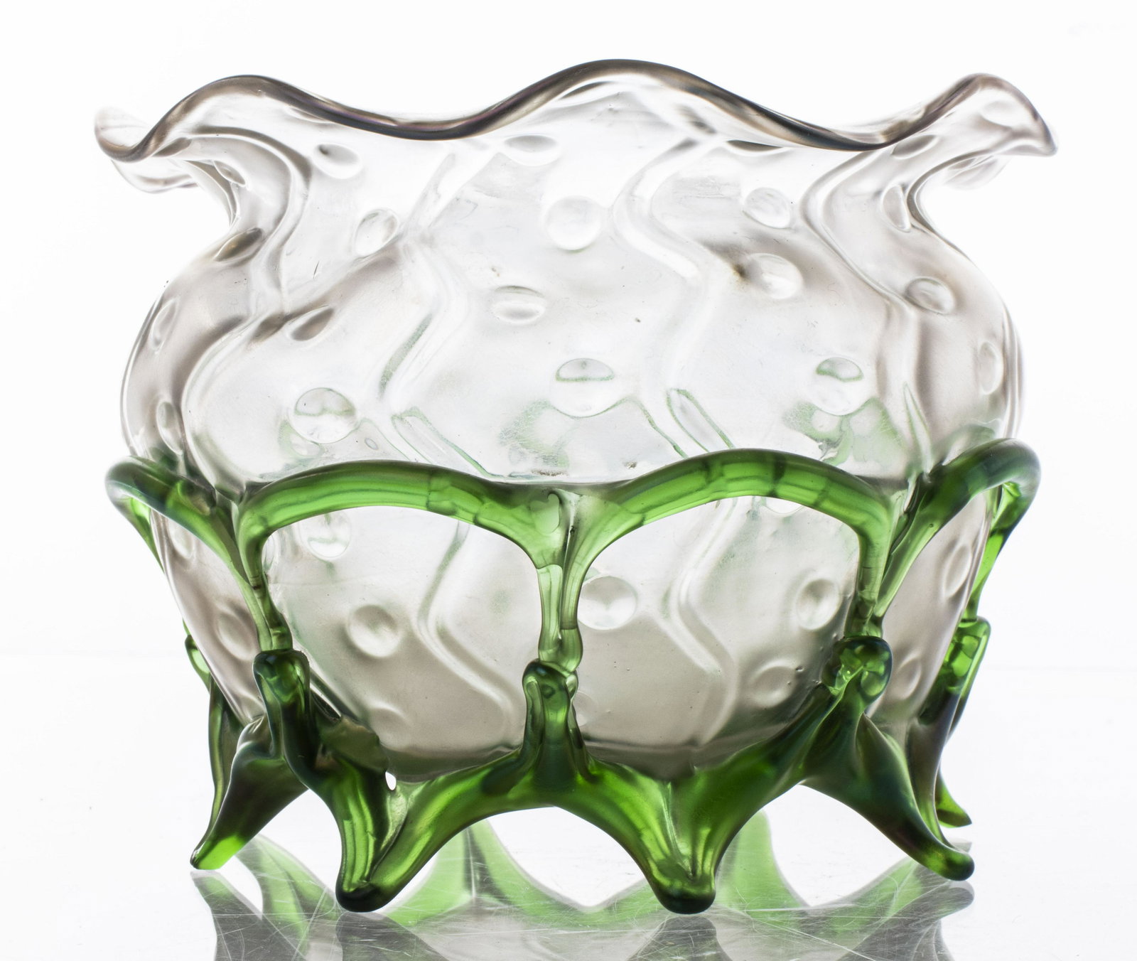 Art Nouveau Glass Vase in the Style of Loetz: Art Nouveau art glass vase in the style of Loetz with round body, ruffled rim and raised on green glass organic form feet. 5" H x 7" diameter. Chip to foot noted.