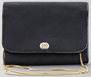 Gucci Black Leather Trimmed Clutch Handbag: Vintage Gucci black leather trimmed clutch handbag with convertible shoulder strap and gold-tone hardware, circa 1970s, interior marked "Made in Italy by Gucci" and lined in black satin. 6” H x 7.75