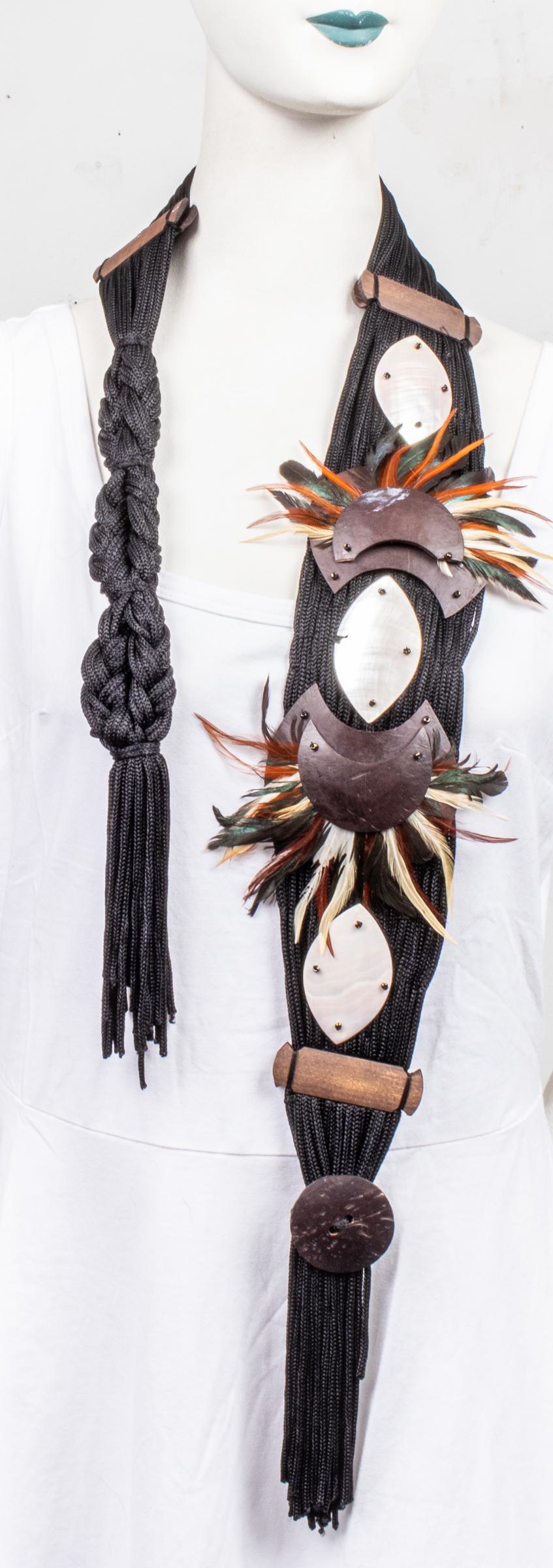 Native American Style Belt with Mother of Pearl: A Native American style belt with mother of pearl, feather and wooden accents. 49" L. Mother of pearl accent needs repair.