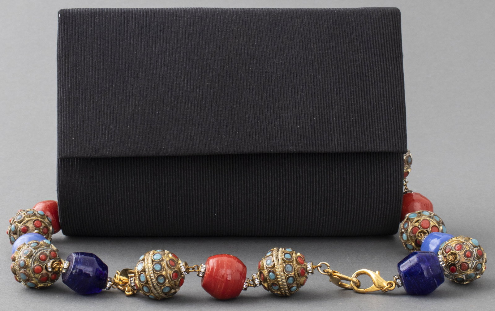 Fendissime by Fendi Evening Bag with Beaded Strap: Fendissime by Fendi cloth evening bag with adjustable strap comprised of enamel and metal & enamel beads, gold-tone hardware, designer logo to snap closure, interior and strap. 4.5" H x 6" L x 3" D.