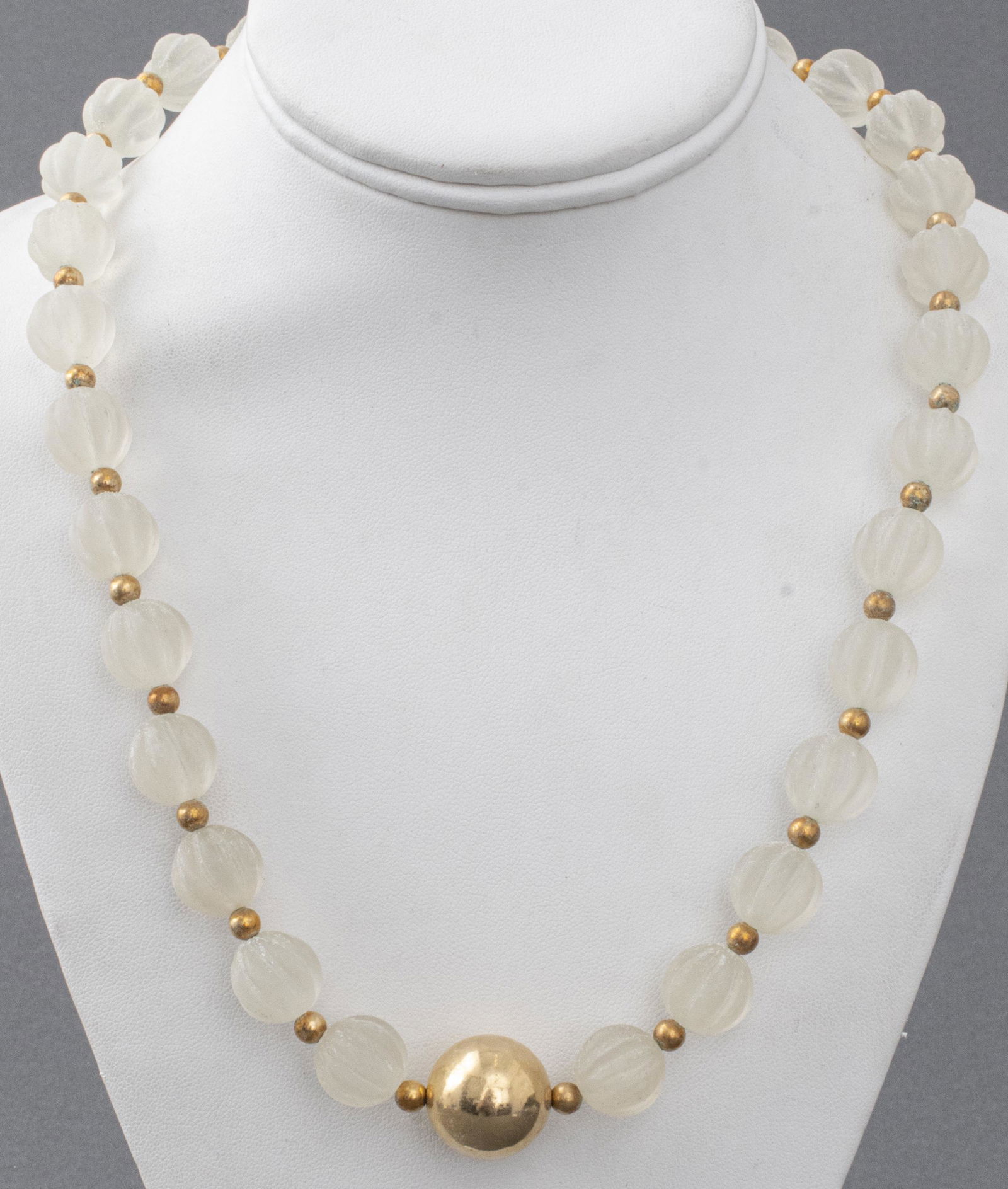 Frosted Quartz Bead & Gold-Fill Necklace: Beaded necklace with frosted ribbed quartz beads alternating with gold-tone beads featuring a central gold-tone bead, the clasp marked "14/20 G." 21.25" L.