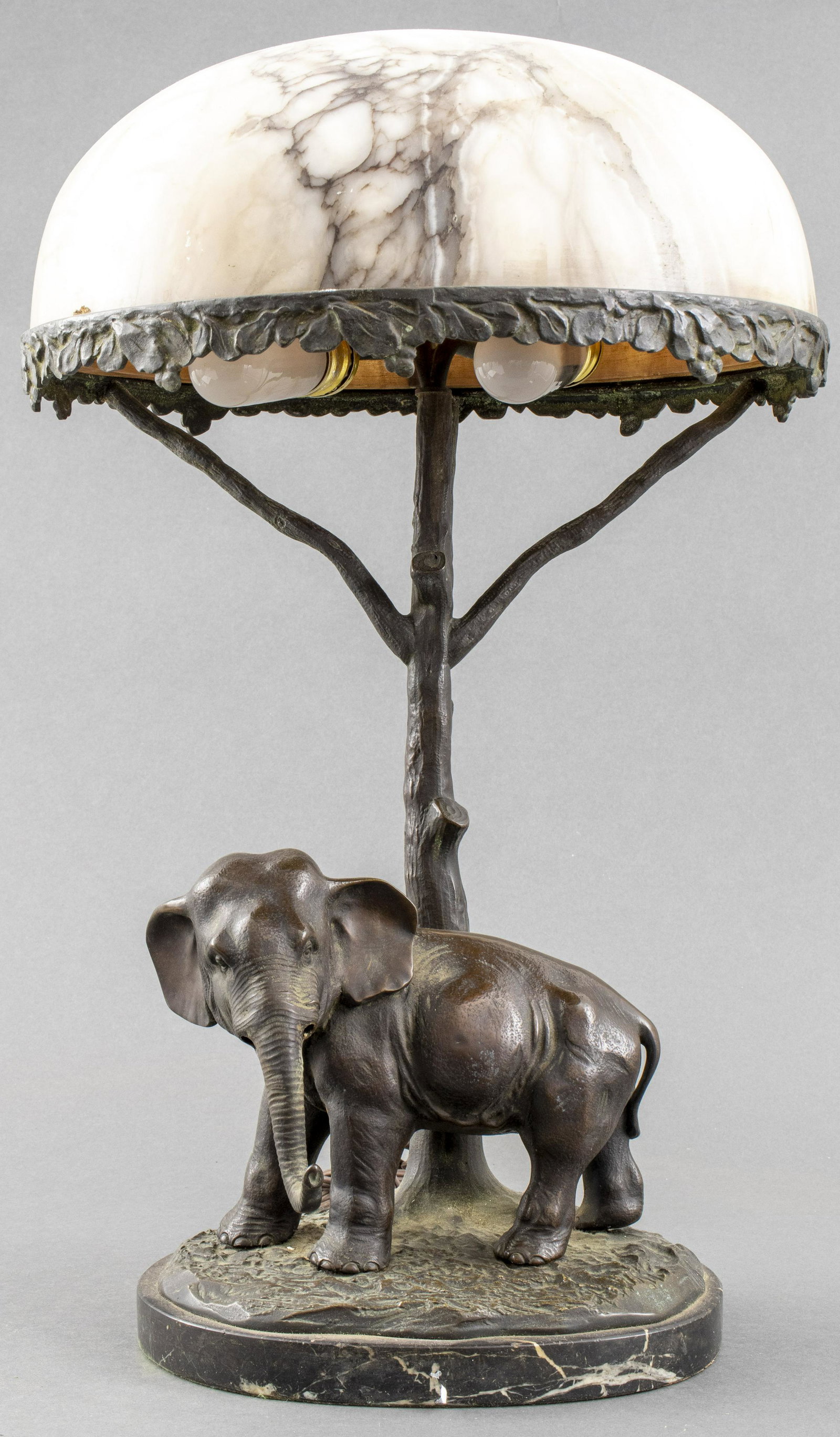 Bruno Zach Manner Bronze & Marble Elephant Lamp: Bruno Zach manner Continental bronze table lamp with marble shade, modeled as an elephant with dark brown patina on naturalistic ground over marble base, with a bronze tree-form stem supporting two li