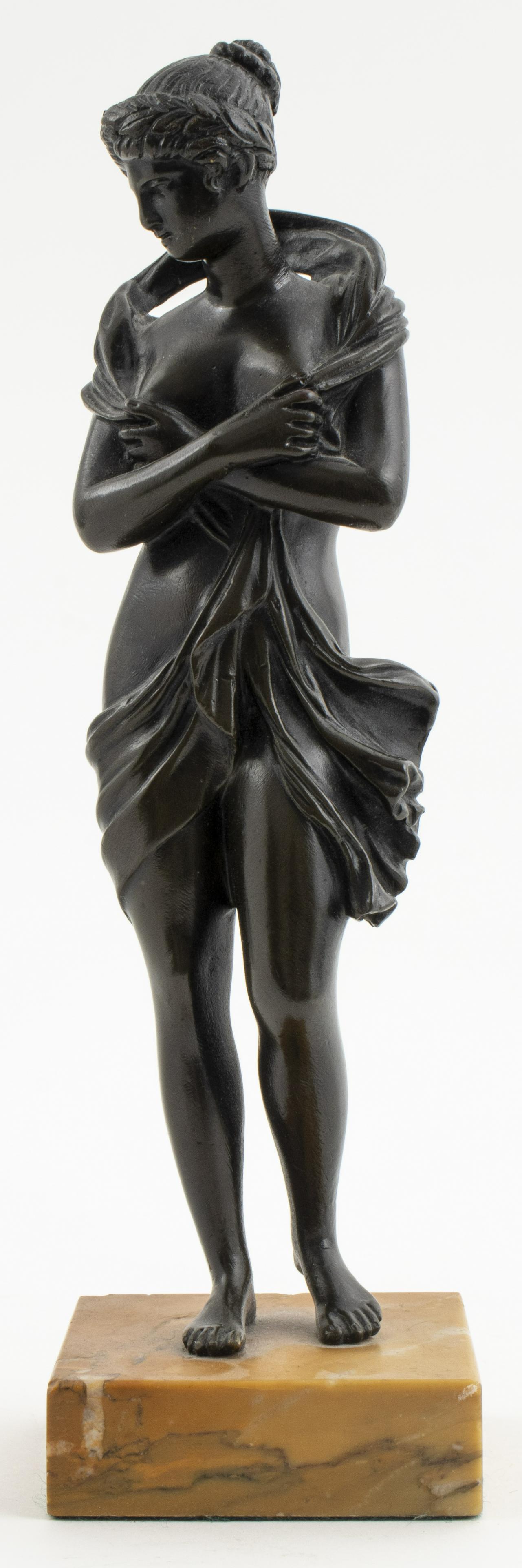 Grand Tour Style Bronze Of Aphrodite: Grand Tour style bronze figure of Aphrodite, modeled gazing down and velificatio (partially nude with billowing garment about her), mounted on yellow marble base. 9.5” H x 2.5” W x 2.5R