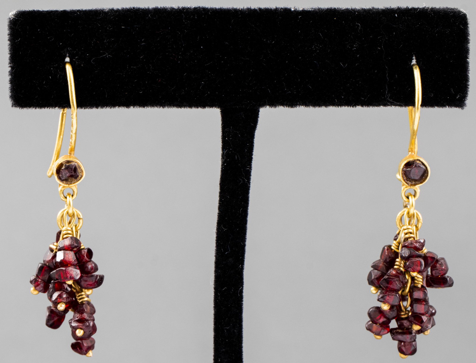Vintage 22K Yellow Gold High Karat Garnet Earrings: Vintage 22K yellow gold high karat wire garnet drop earrings, marked with maker's mark and hallmarks. Earrings: 1.62" L x 0.62" W. Approx: 3.5 dwt inclusive.