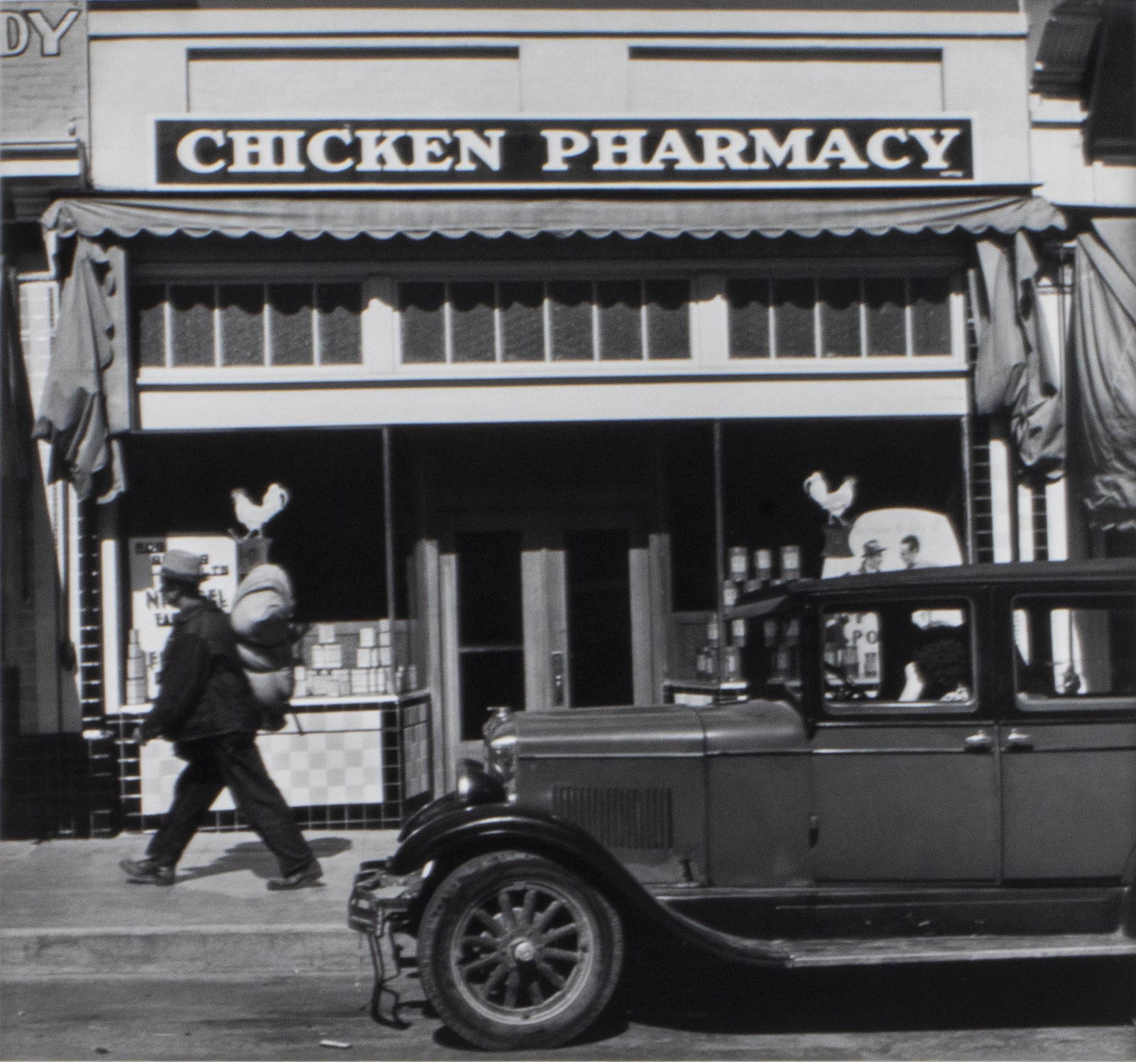 John Gutmann "The Chicken Pharmacy" Gelatin Silver: John Gutmann (German-American, 1905-1998) "The Chicken Pharmacy, Petaluma, California," gelatin silver print, 1938, printed in 1974, signed on reverse, bearing San Francisco Museum of Art label on mat