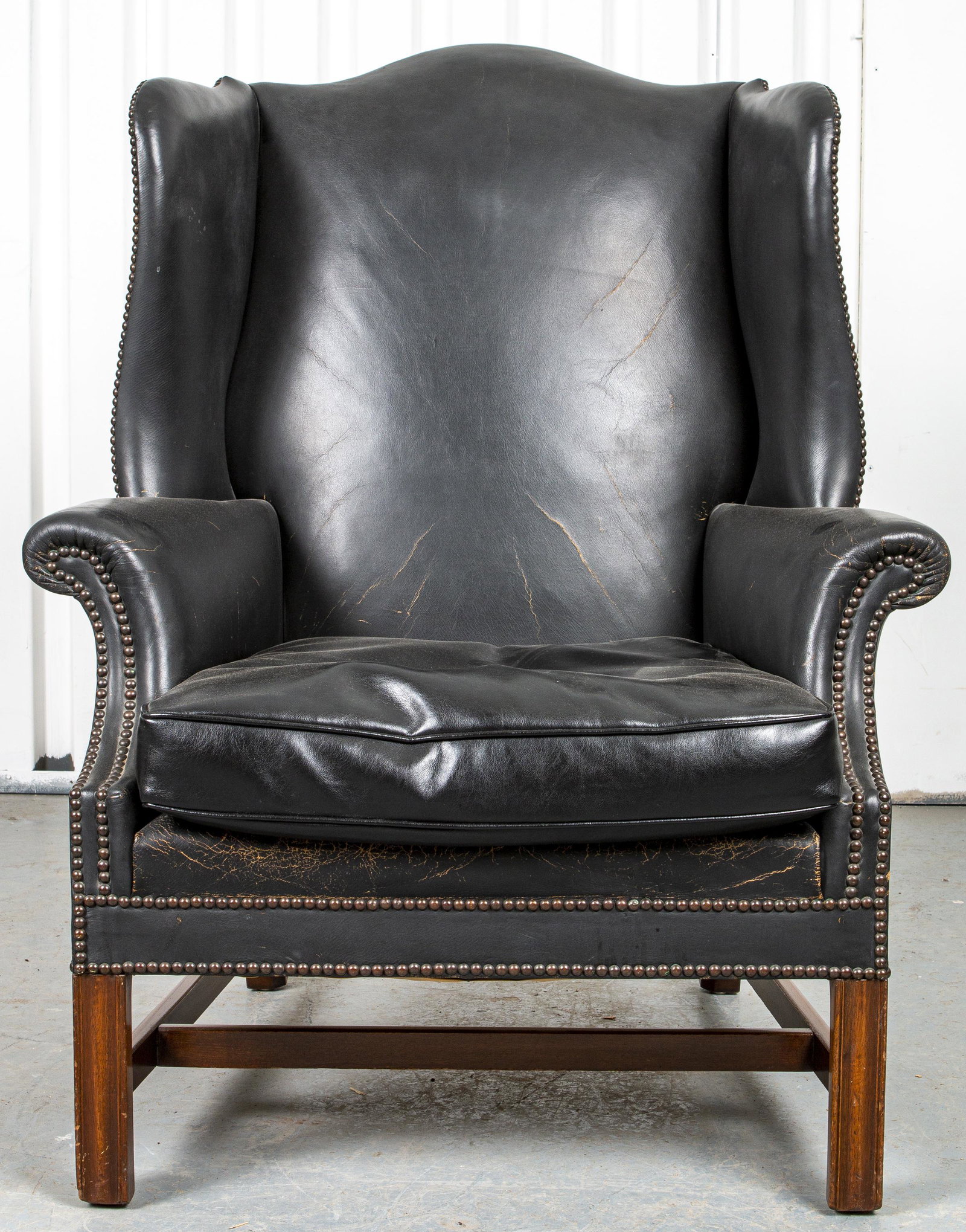 Georgian Chippendale Style Leather Wing Armchair: Georgian Chippendale style black leather upholstered wing armchair. 42” H x 33” W x 28.5” D
